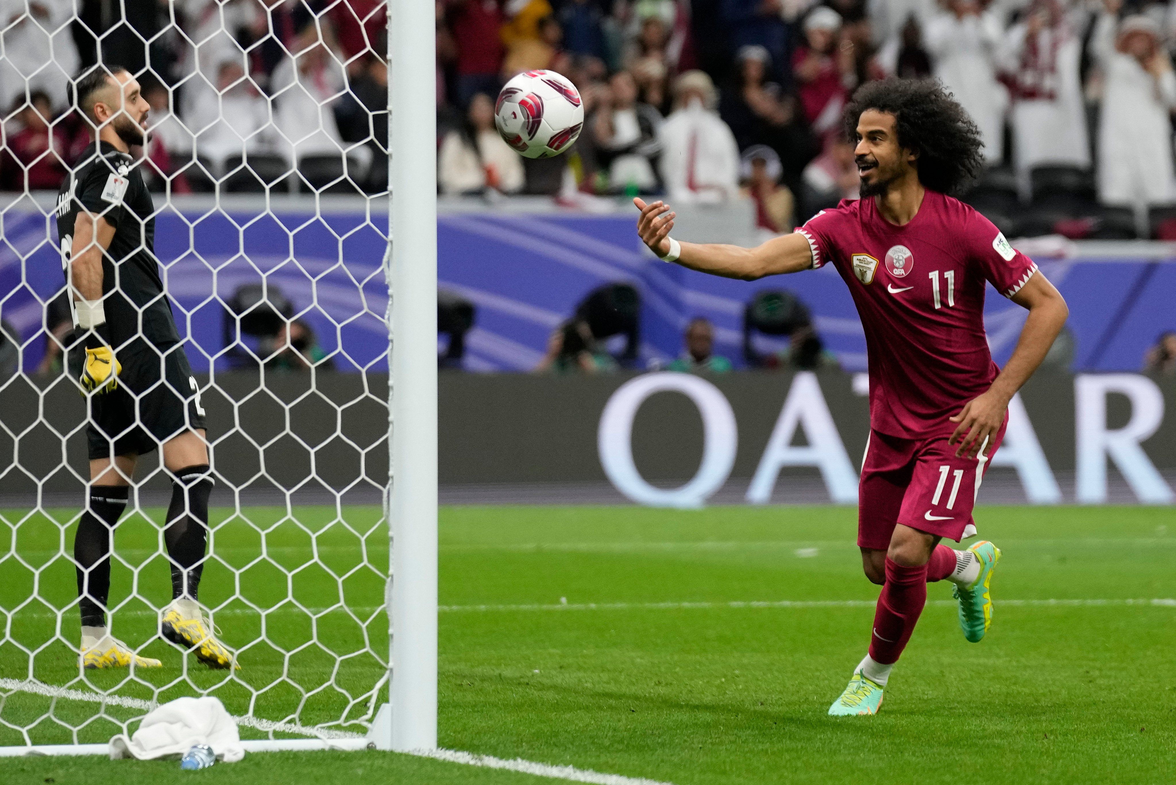 Qatar’s Akram Afif celebrates after scoring his team’s winner against Palestine. Photo: AP