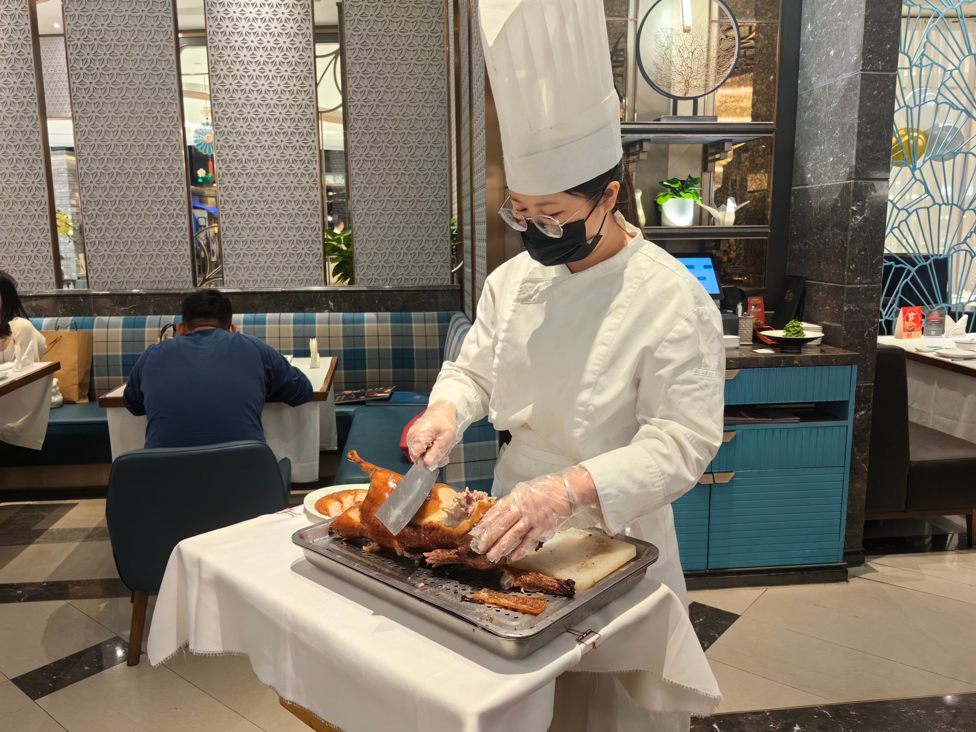 A server slices a course of Beijing fruitwood roast duck at Blossom Palaces in Shenzhen, China, where one of our writers eats on their day of food, drink and leisure in the city to compare it with Hong Kong. Photo: Young Wang