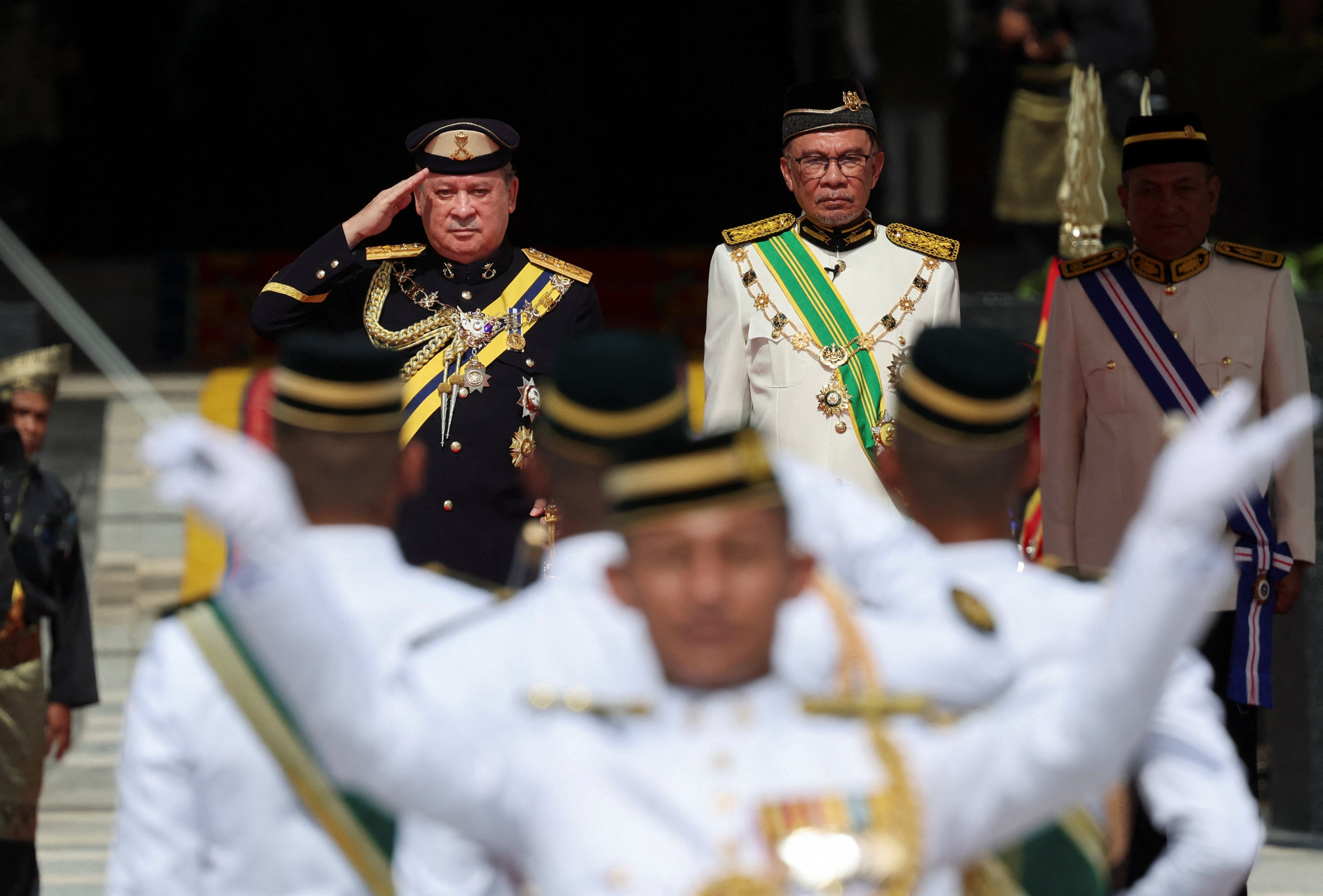 Sultan Ibrahim Iskandar of Johor (left), beside Prime Minister Anwar Ibrahim, salutes a guard of honour at the National Palace in Kuala Lumpur on Wednesday during his coronation as Malaysia’s 17th king. Photo: Reuters