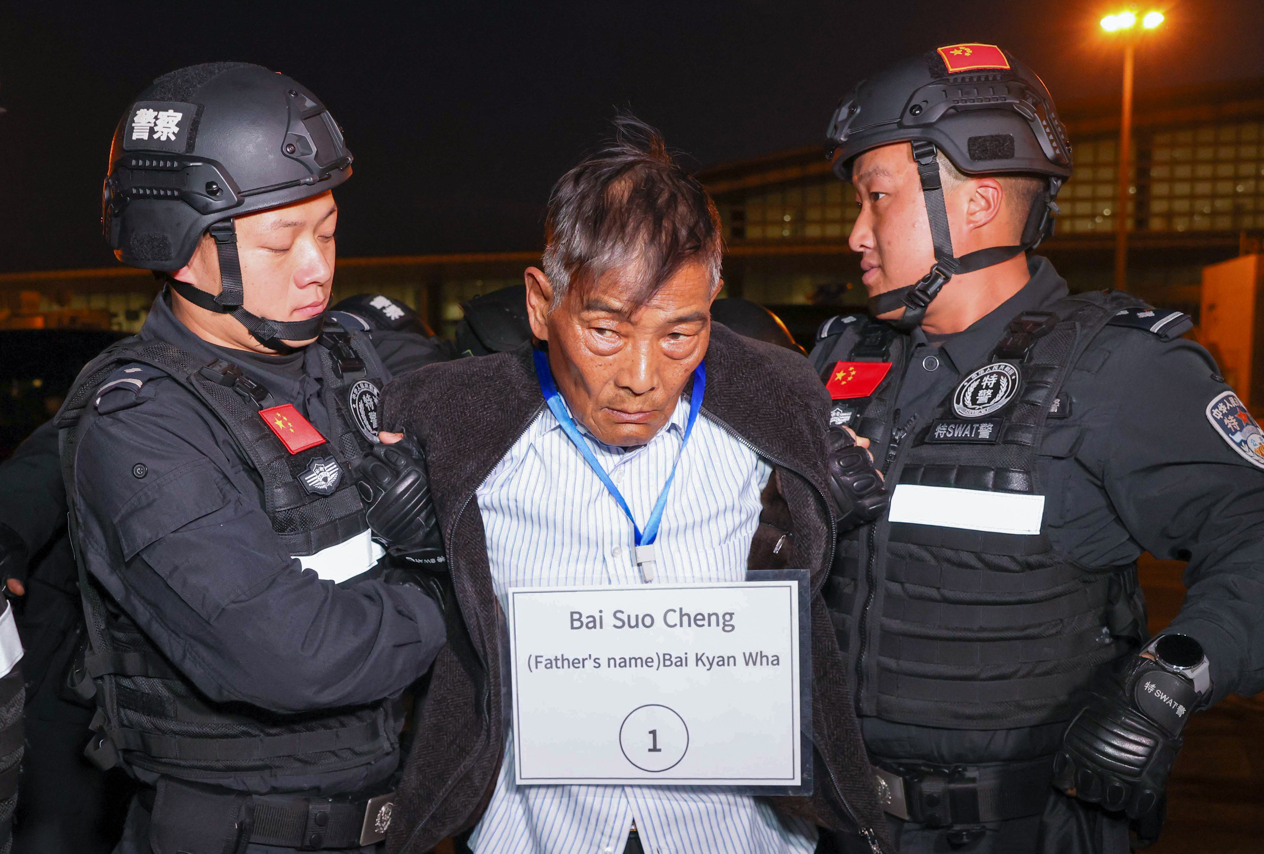 Suspected crime ring leader Bai Suocheng (centre) is handed over to Chinese police at the Naypyidaw International Airport in Myanmar’s capital on Tuesday. Photo: Xinhua
