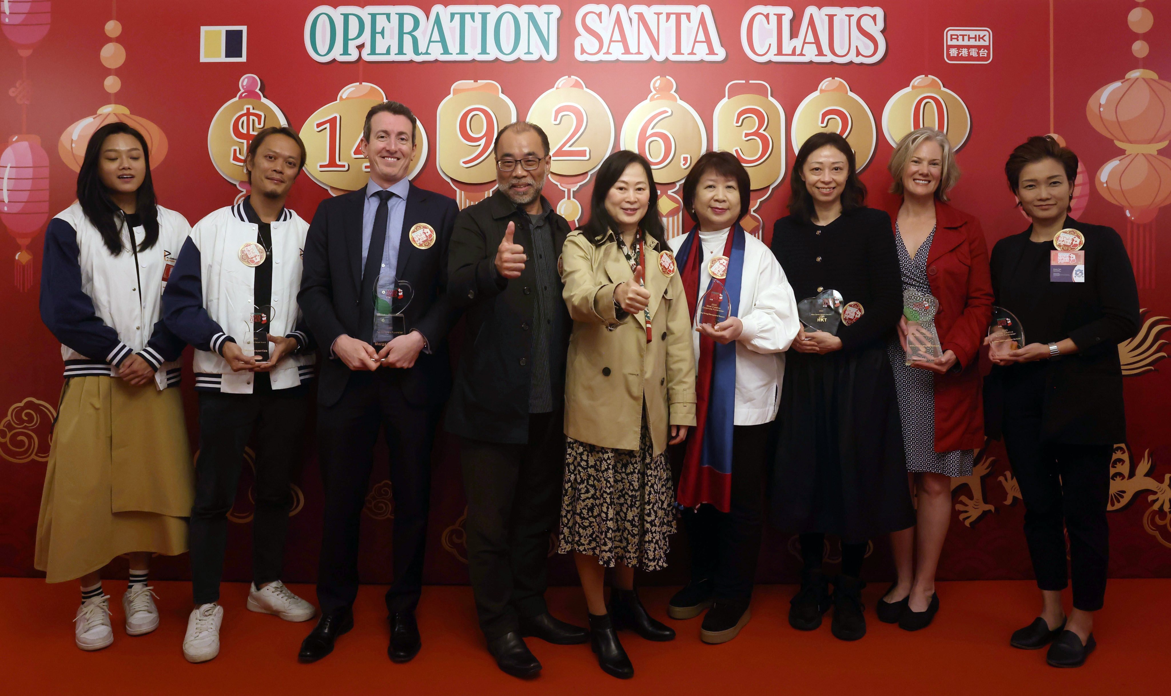 The Operation Santa Claus closing ceremony, with (from left) Peony Ho, Evan Li, David Wallis, Vincent Lee, Post editor-in-chief Tammy Tam, Mary Lam, Yen Lee, Rebecca Marans and Grace Yen. Photo: Jonathan Wong