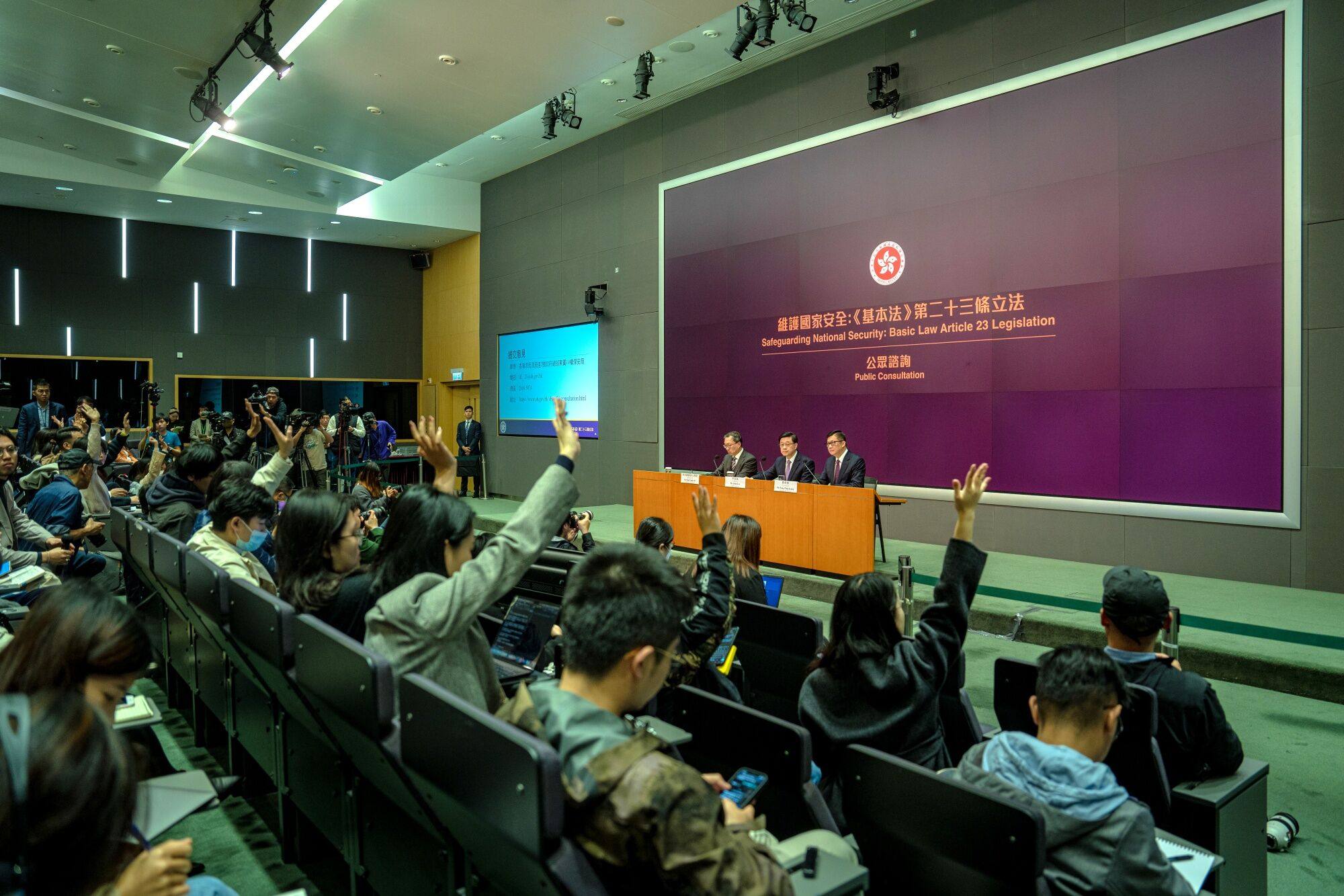 Hong Kong’s chief executive John Lee (centre), secretary for justice Paul Lam (left) and secretary for security Chris Tang hold a news conference announcing details of the city’s new domestic security law. Photo: Bloomberg