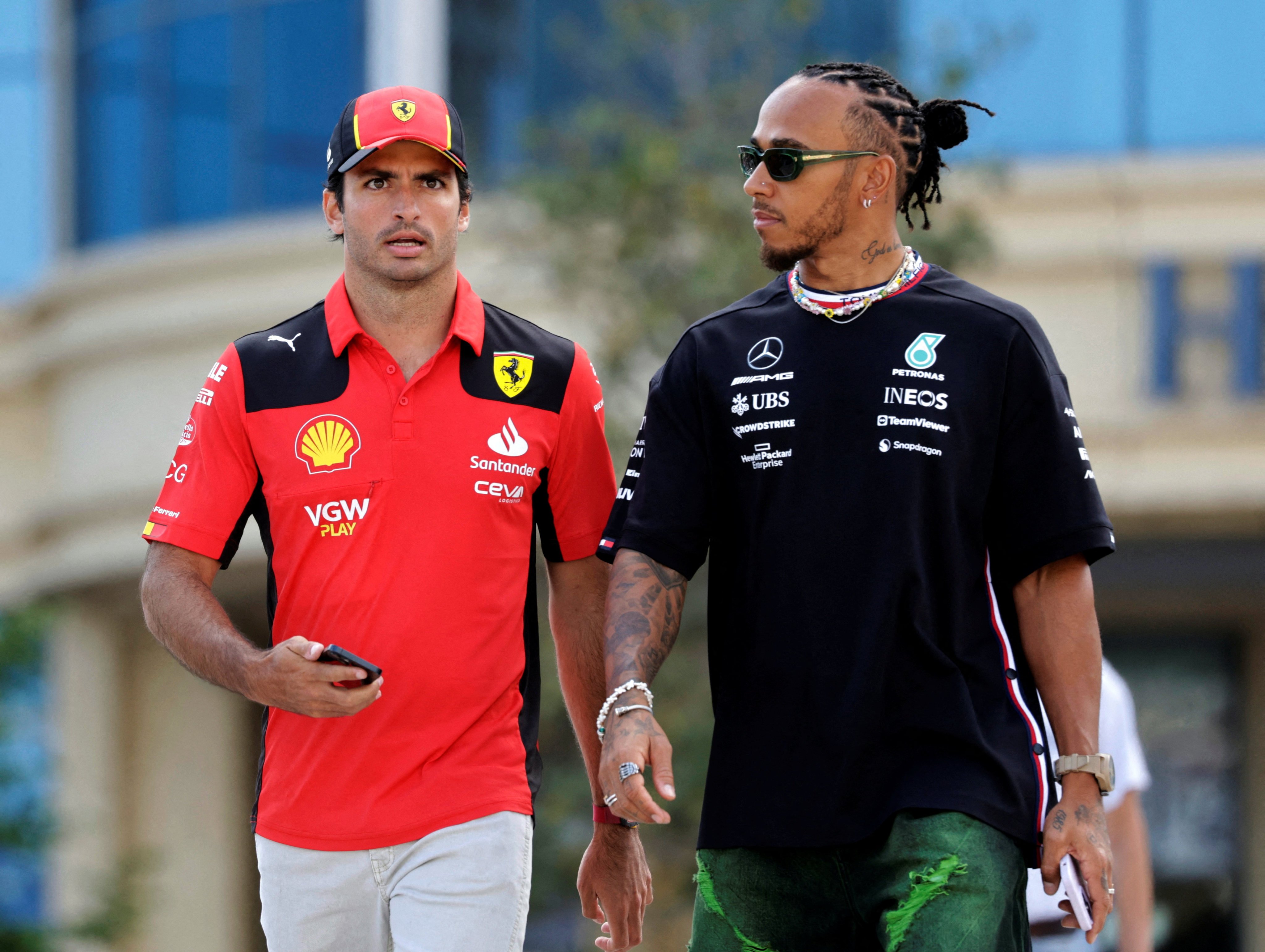 Ferrari’s Carlos Sainz Jr. and Mercedes’ Lewis Hamilton walk together ahead of the Azerbaijan Grand Prix in April, 2023. Photo: Reuters