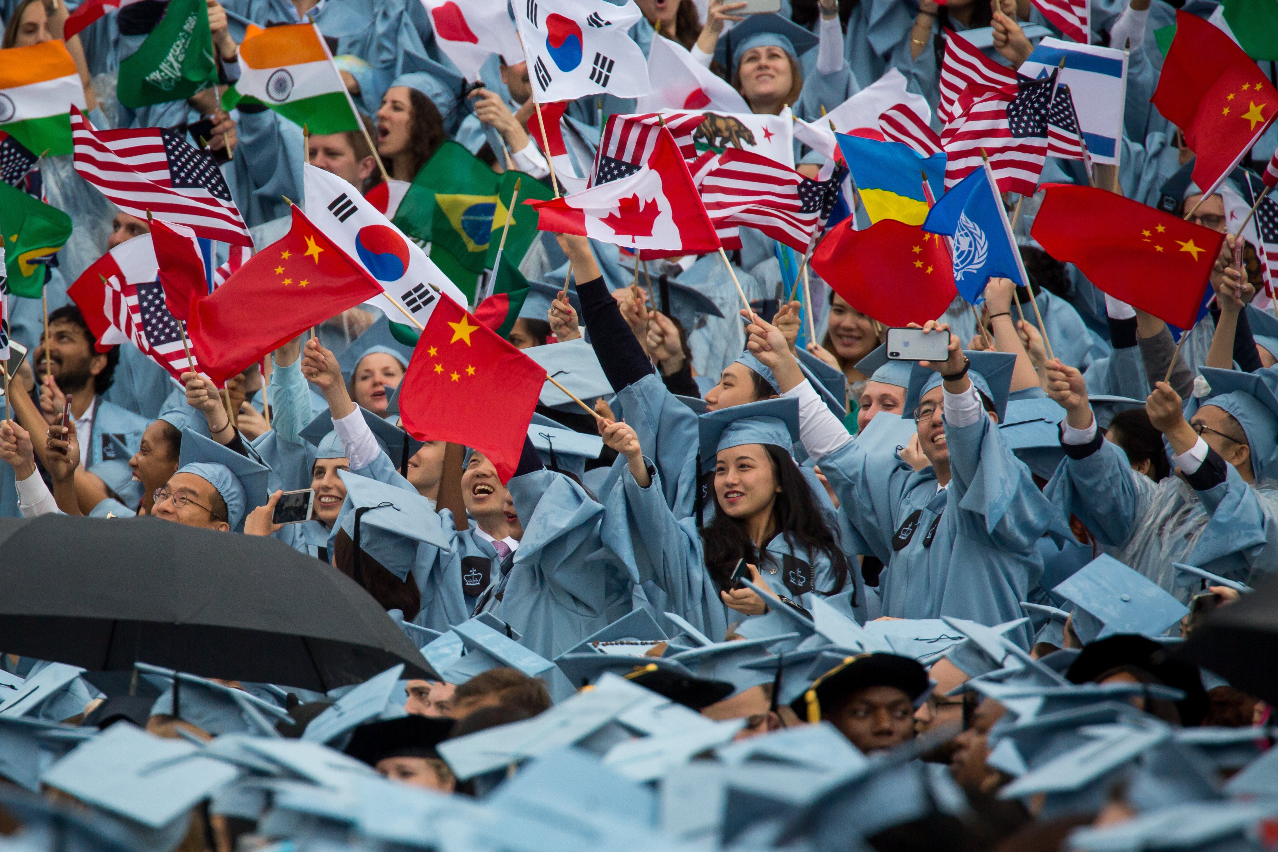 Graduates from the Columbia University in New York wave flags during their commencement ceremony on May 16, 2018. File photo: Xinhua