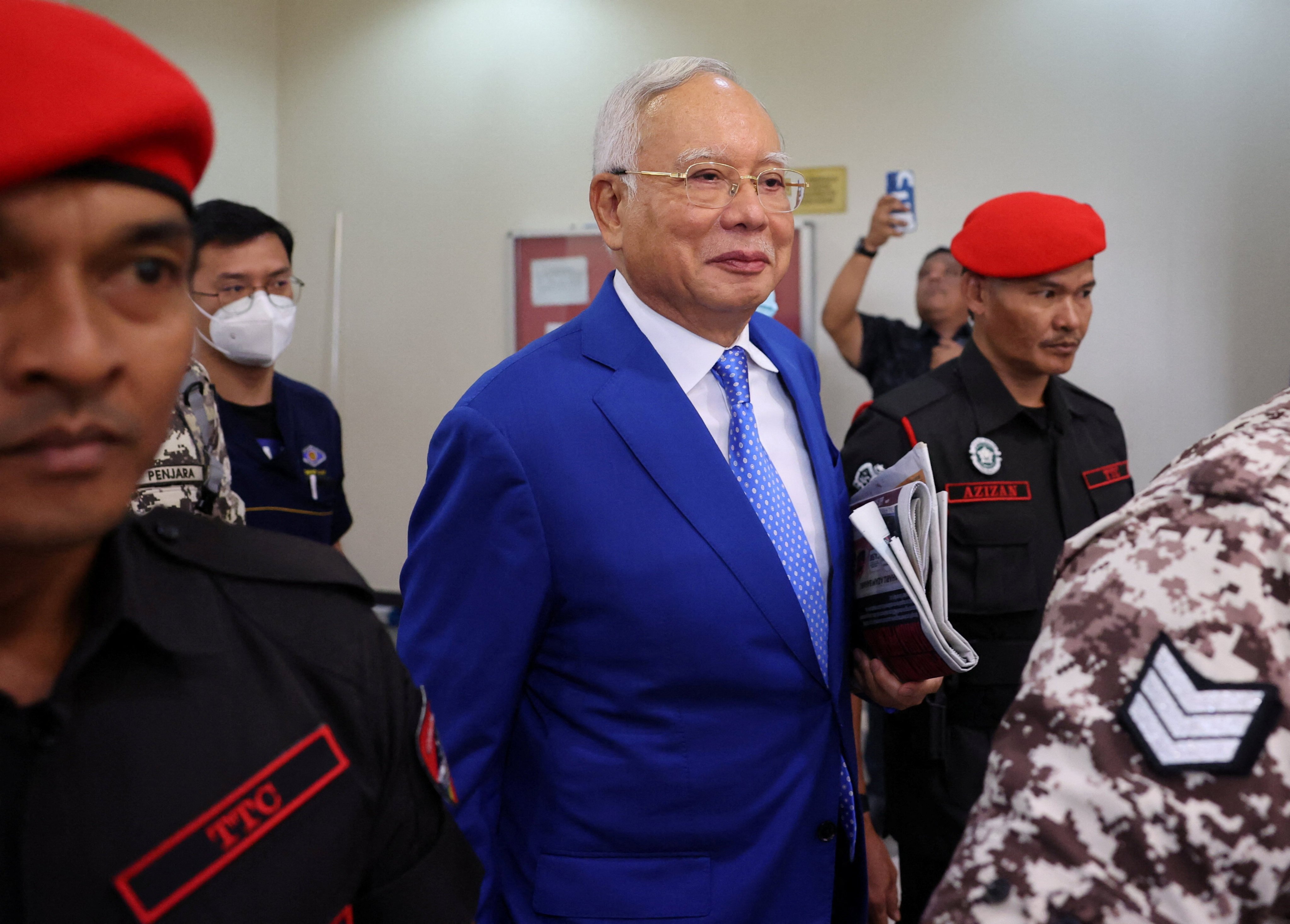 Former Malaysian prime minister Najib Razak leaves a court in Kuala Lumpur last month escorted by prison officials. Photo: Reuters