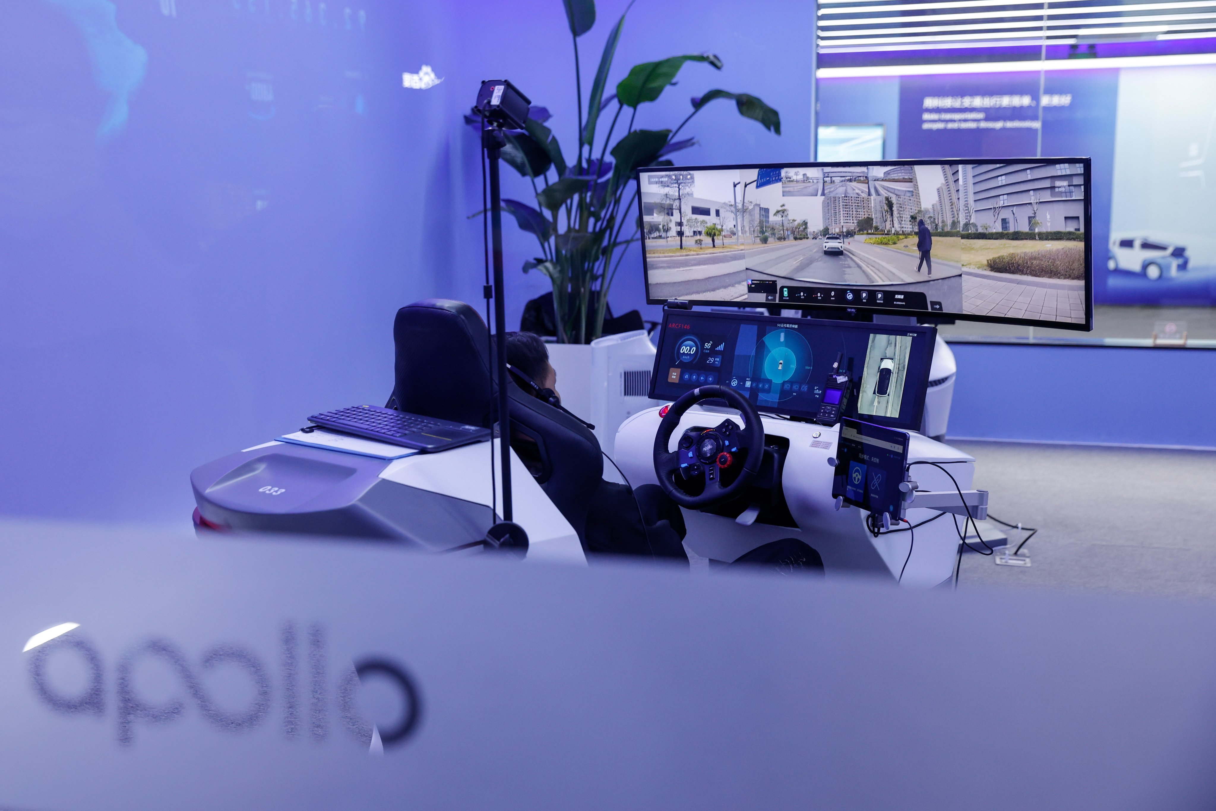 A Baidu employee works on an AI-powered driverless taxi simulator at the company’s Apollo Park centre in Beijing on January 30. Artificial intelligence is poised to make many driving jobs and those in other professions obsolete in the near future, increasing the need for governments to make the transition more equitable. Photo: EPA-EFE