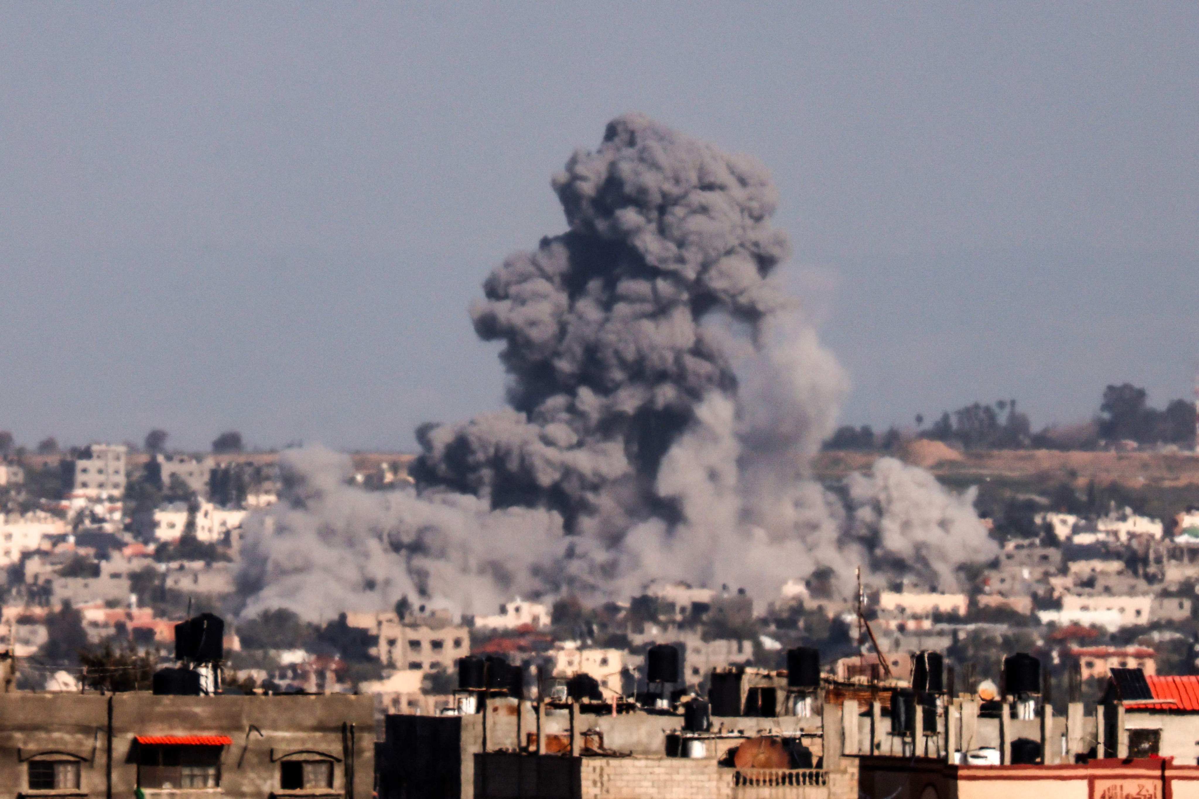 Smoke rises over buildings in Khan Younis during Israeli bombardment on Thursday. Photo: AFP