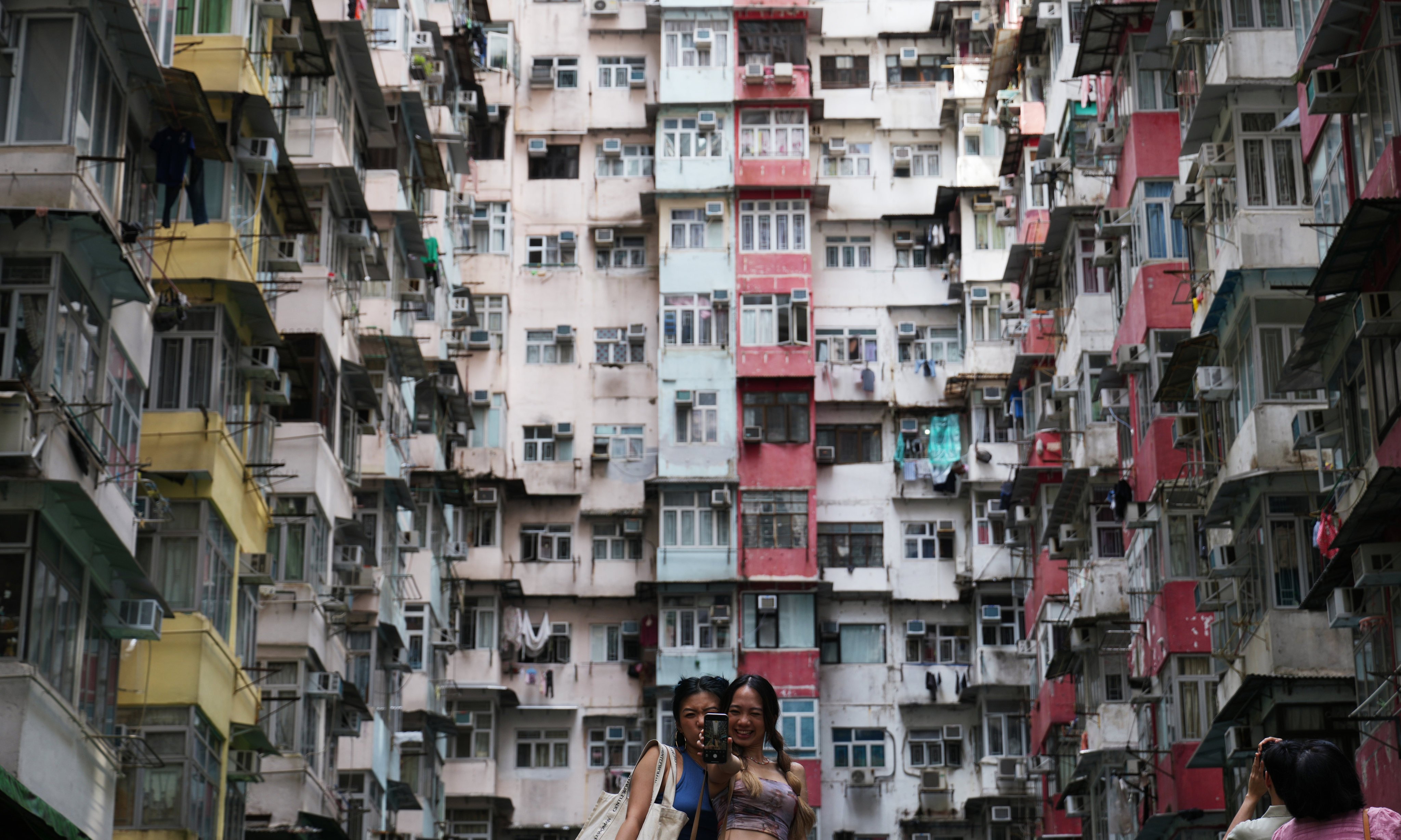 Tourists take photos at Montane Mansion, also known as the “Monster Building”, in Quarry Bay in 2023. The popularity of the building, which  was featured in a Transformers movie, is just one example of changing tourist tastes. Photo: Sam Tsang