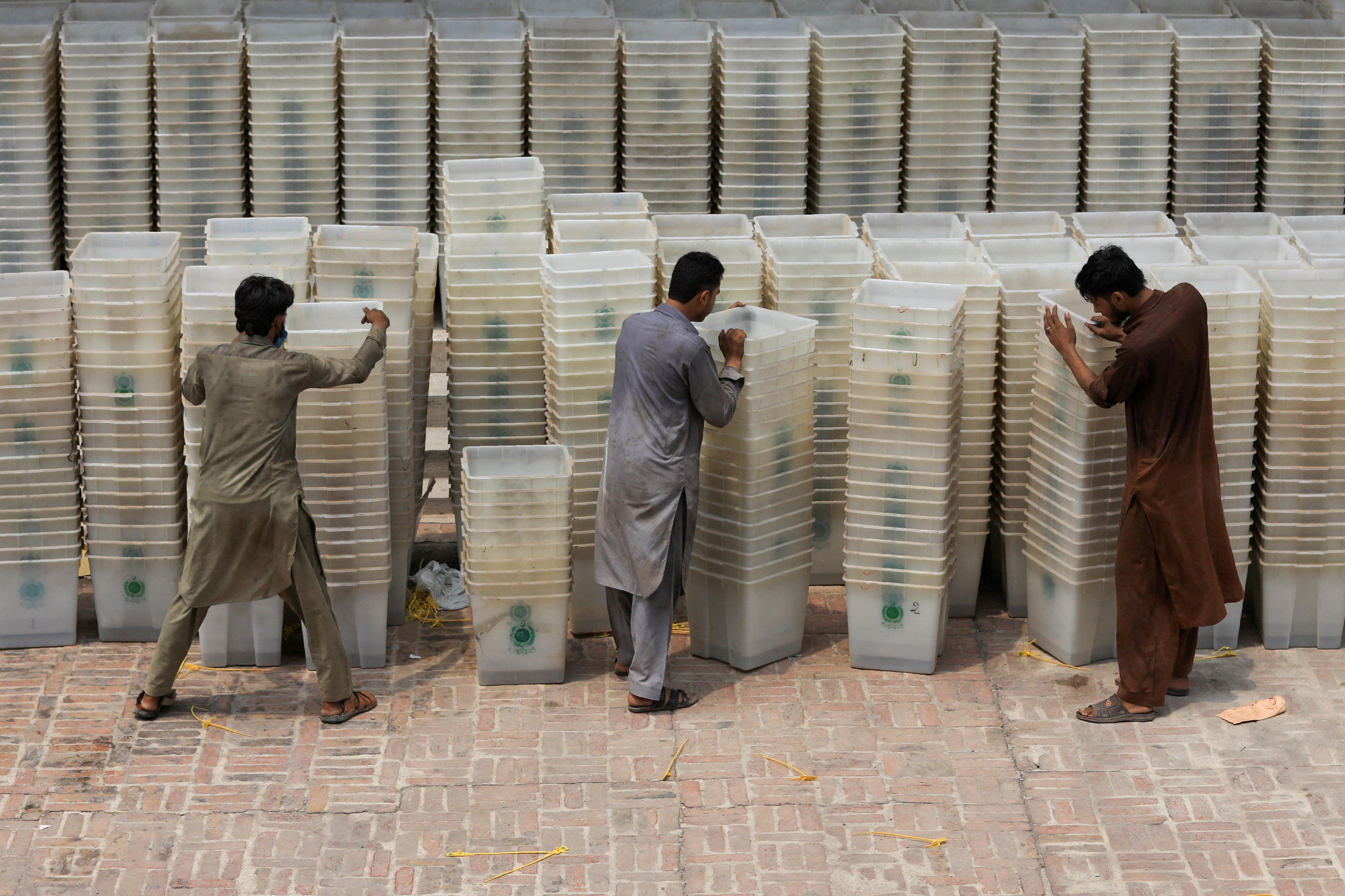Workers sort out ballot boxes before dispatching them to polling stations ahead of Pakistan’s general election in 2018. Photo: Reuters