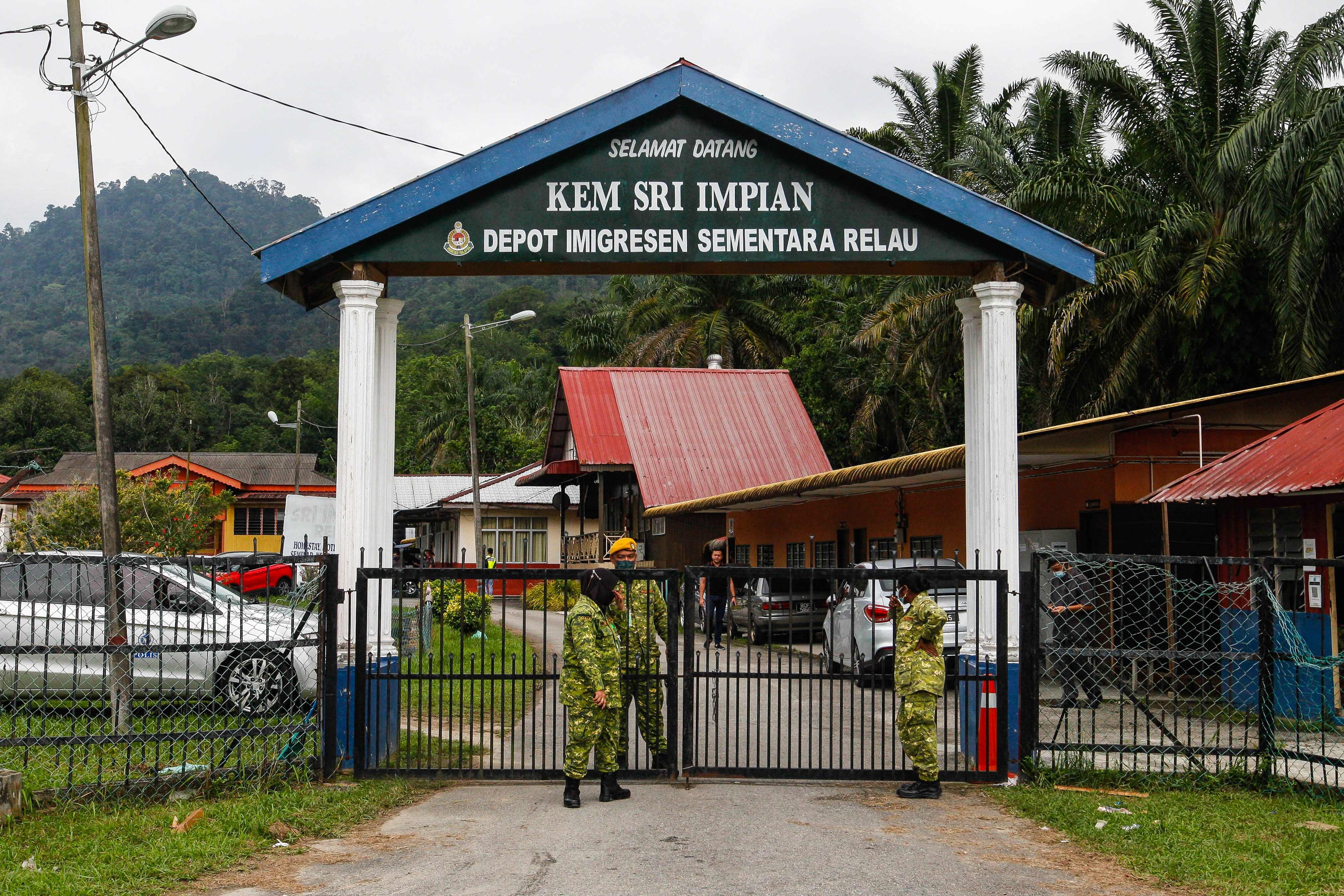 Members of Malaysia’s paramilitary civil volunteer corps guard the main gate of a Penang detention centre following the 2022 breakout. Photo: AFP