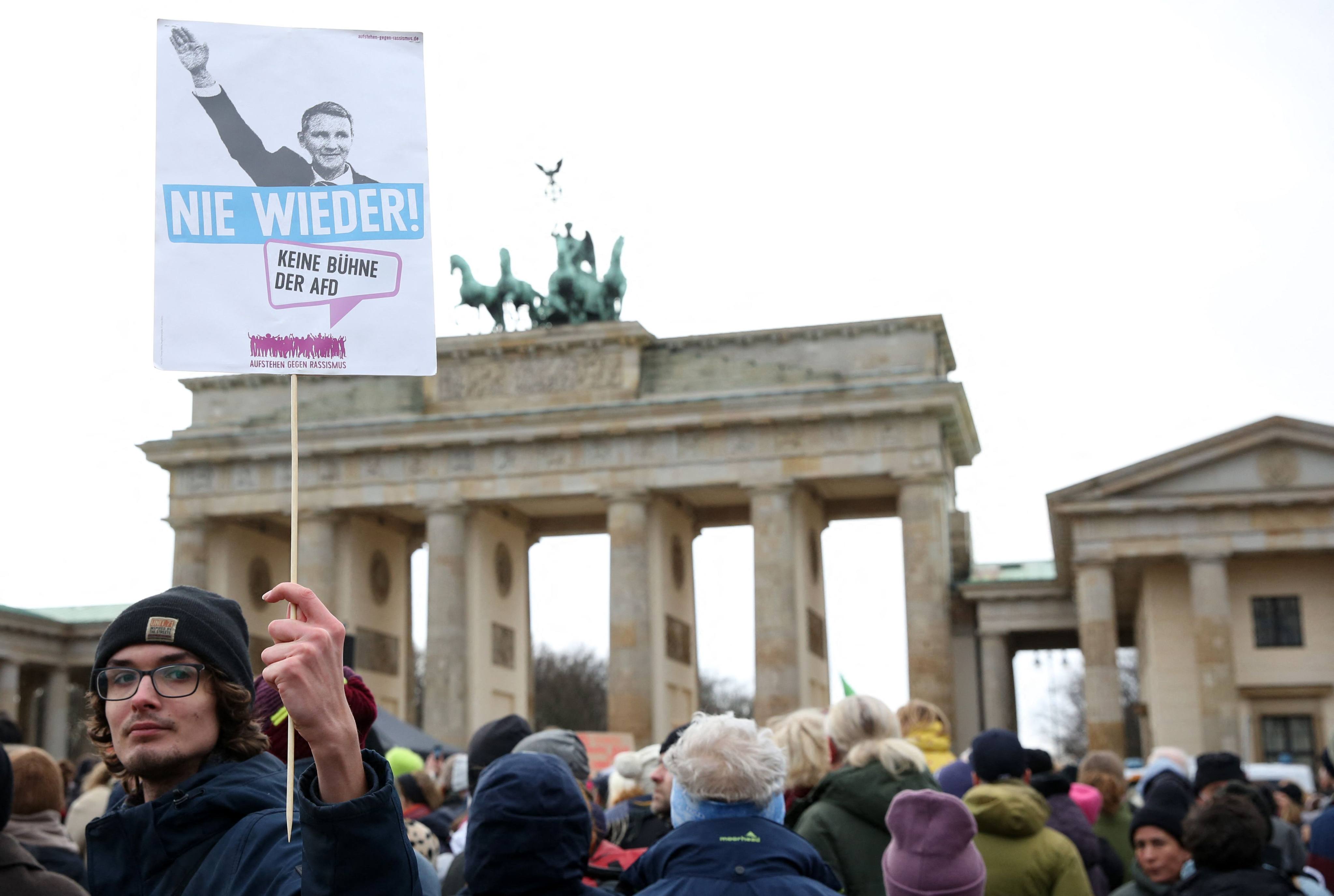 A demonstrator in Berlin, Germany, holds up a placard showing a far-right leader giving the Nazi salute and reading ‘Never Again’, as people demonstrate against extremism and the policy of the anti-immigration Alternative for Germany (AfD) party. File photo: AFP