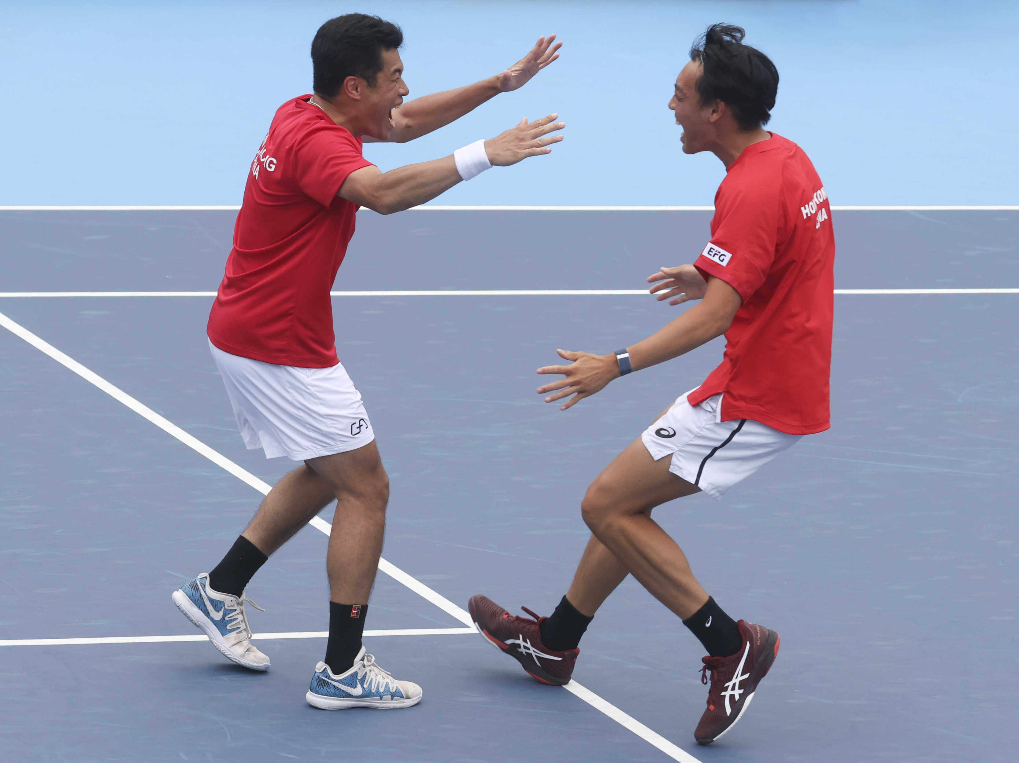 Hong Kong’s Kevin Wong (left) and Coleman Wong celebrate as their doubles win seals overall victory in the tie. Photo: Yik Yeung-man