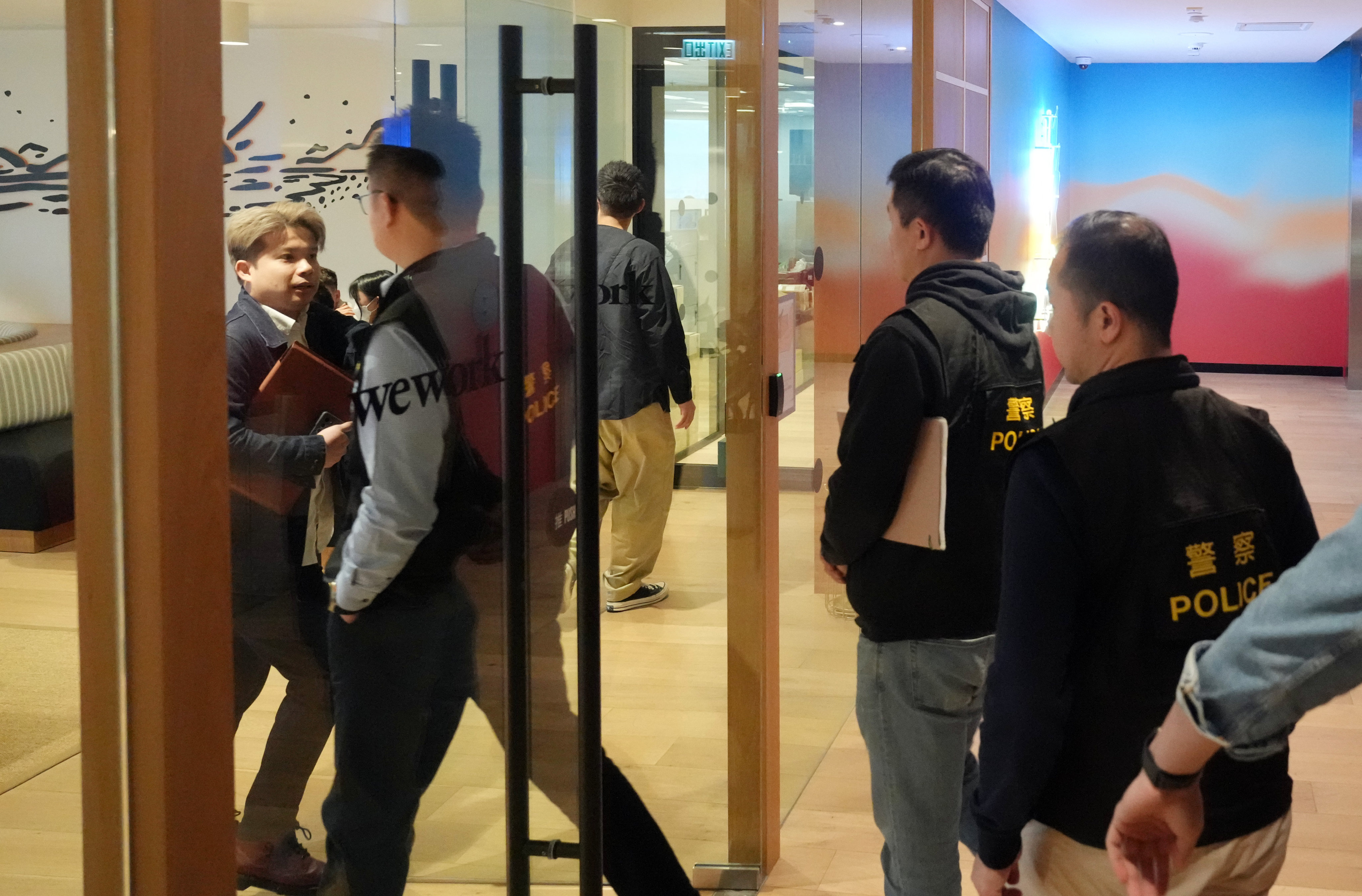 Police officers enter KeeTa’s offices at Lee Garden One. Photo: Sam Tsang