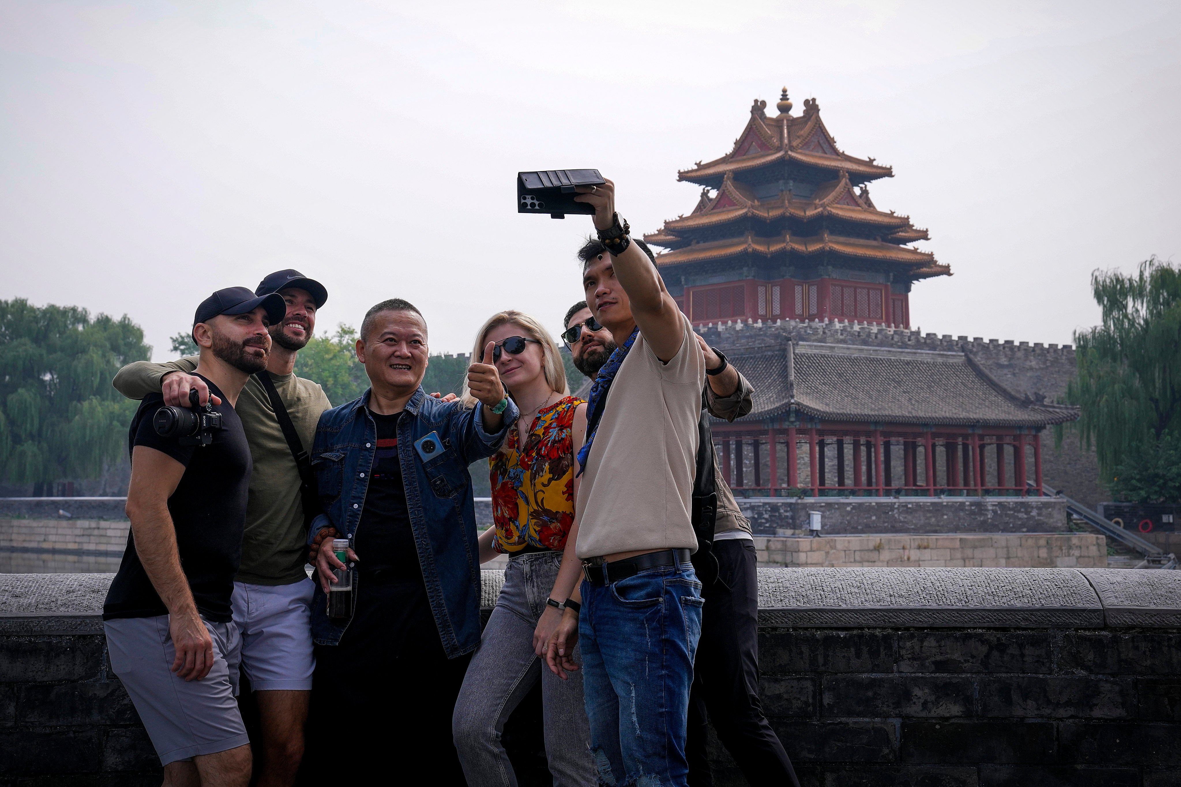 China’s economic planners are looking to beef up tourism and investment by enticing foreigners to visit and spend, according to analysts. Photo: AP