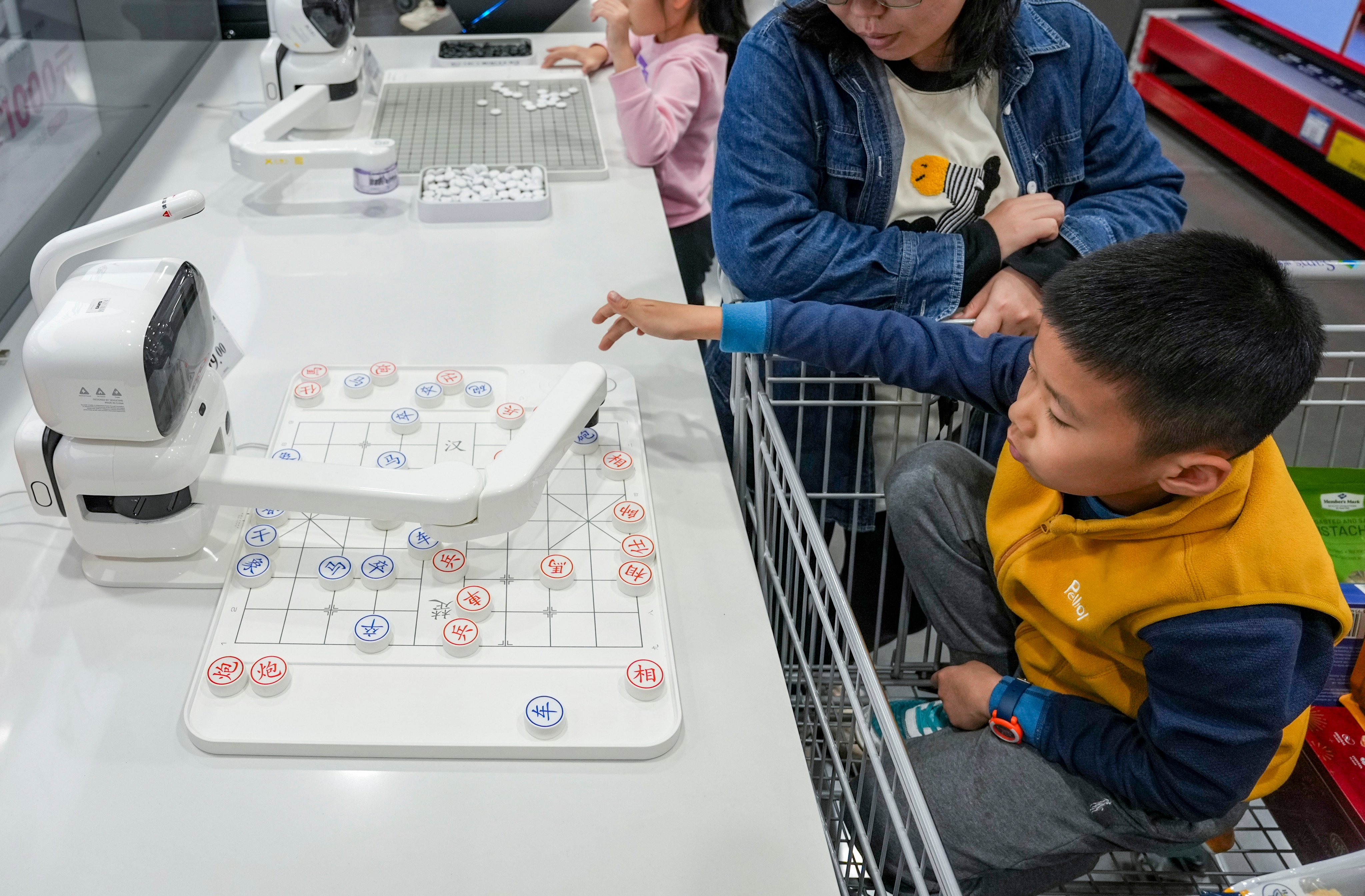 A boy plays chess with a robotic arm powered by artificial intelligence at a Sam’s Club in Qianhai, Shenzhen, on January 7. While Hongkongers are showing great interest in heading north to shop in megastores, Shenzhen also offers some lessons in urban planning. Photo: Eugene Lee