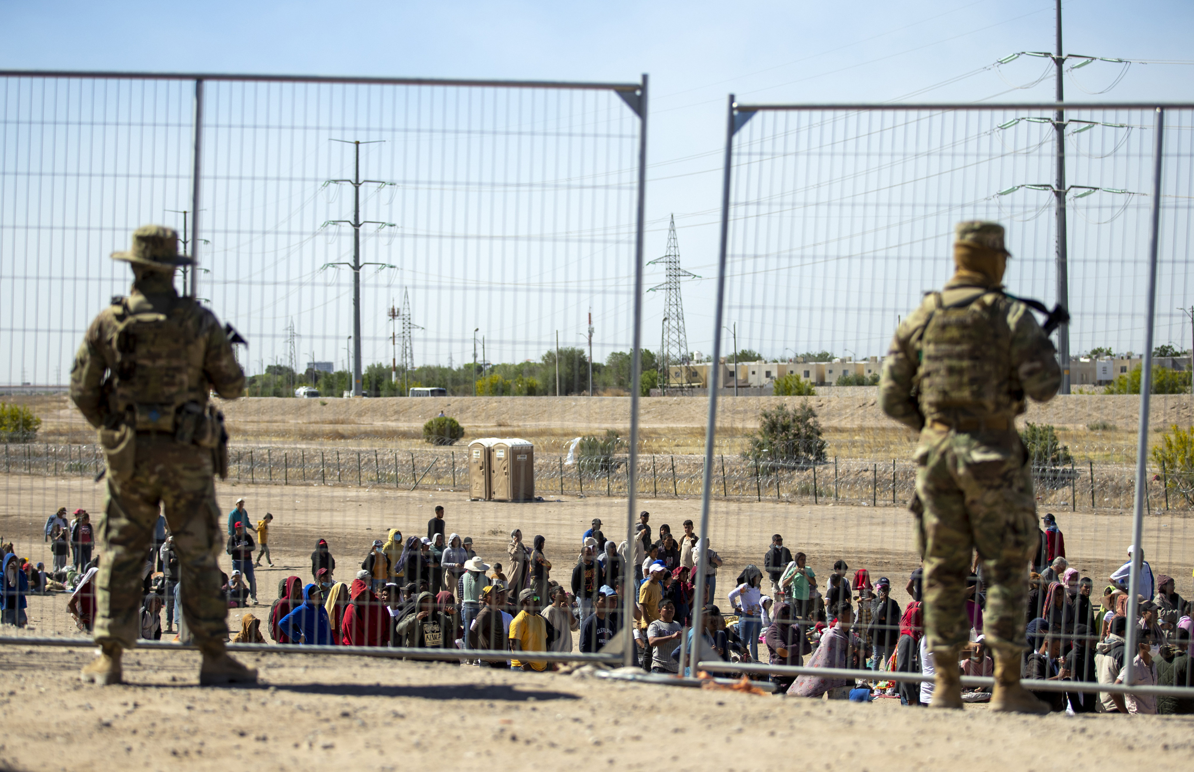Migrants wait to enter into El Paso, Texas, under the watch of the Texas National Guard. File photo: AP