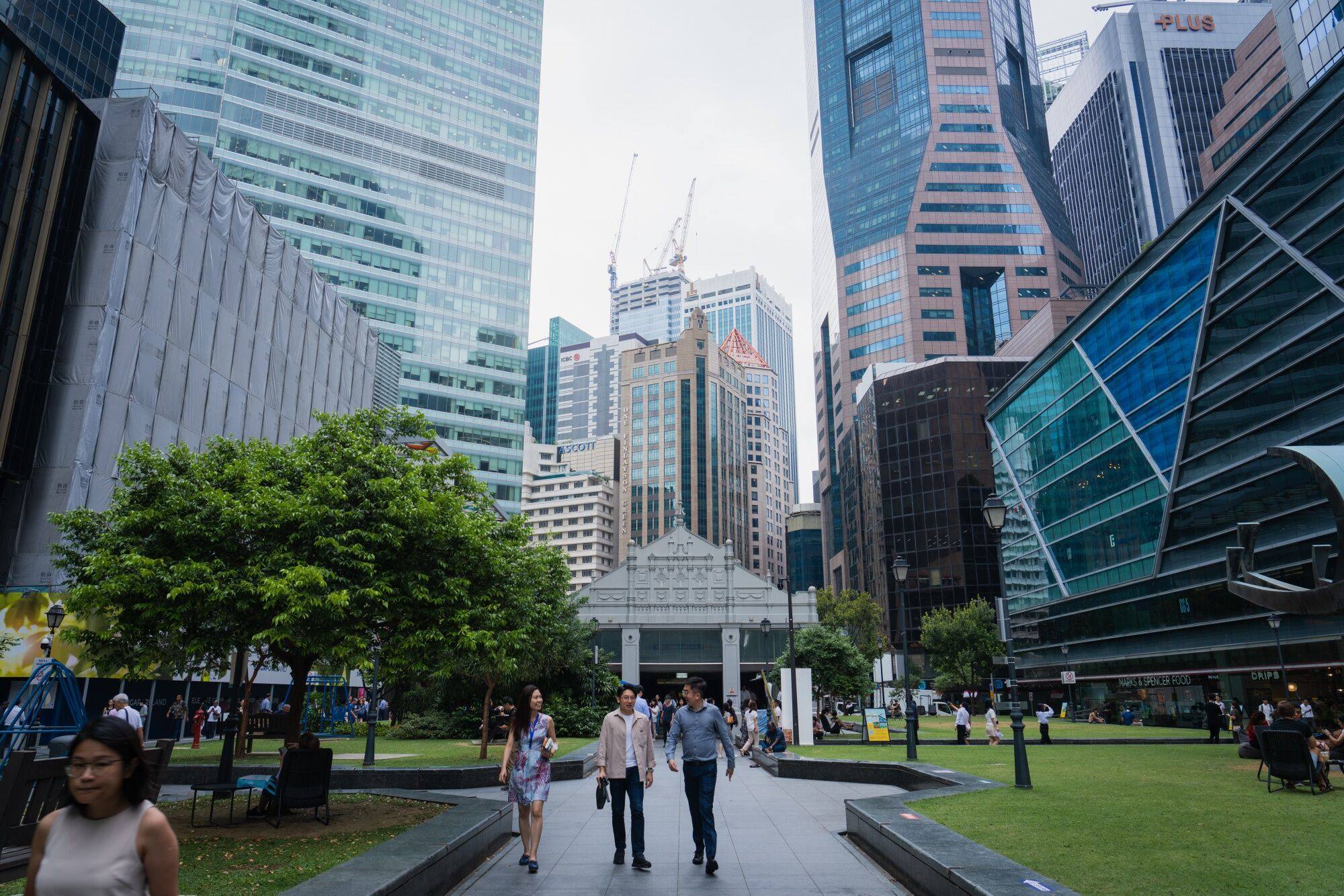 People walk through Singapore’s central business district on August 31, 2023. The city state has become a hub for both Western and Chinese investment. Photo: Bloomberg