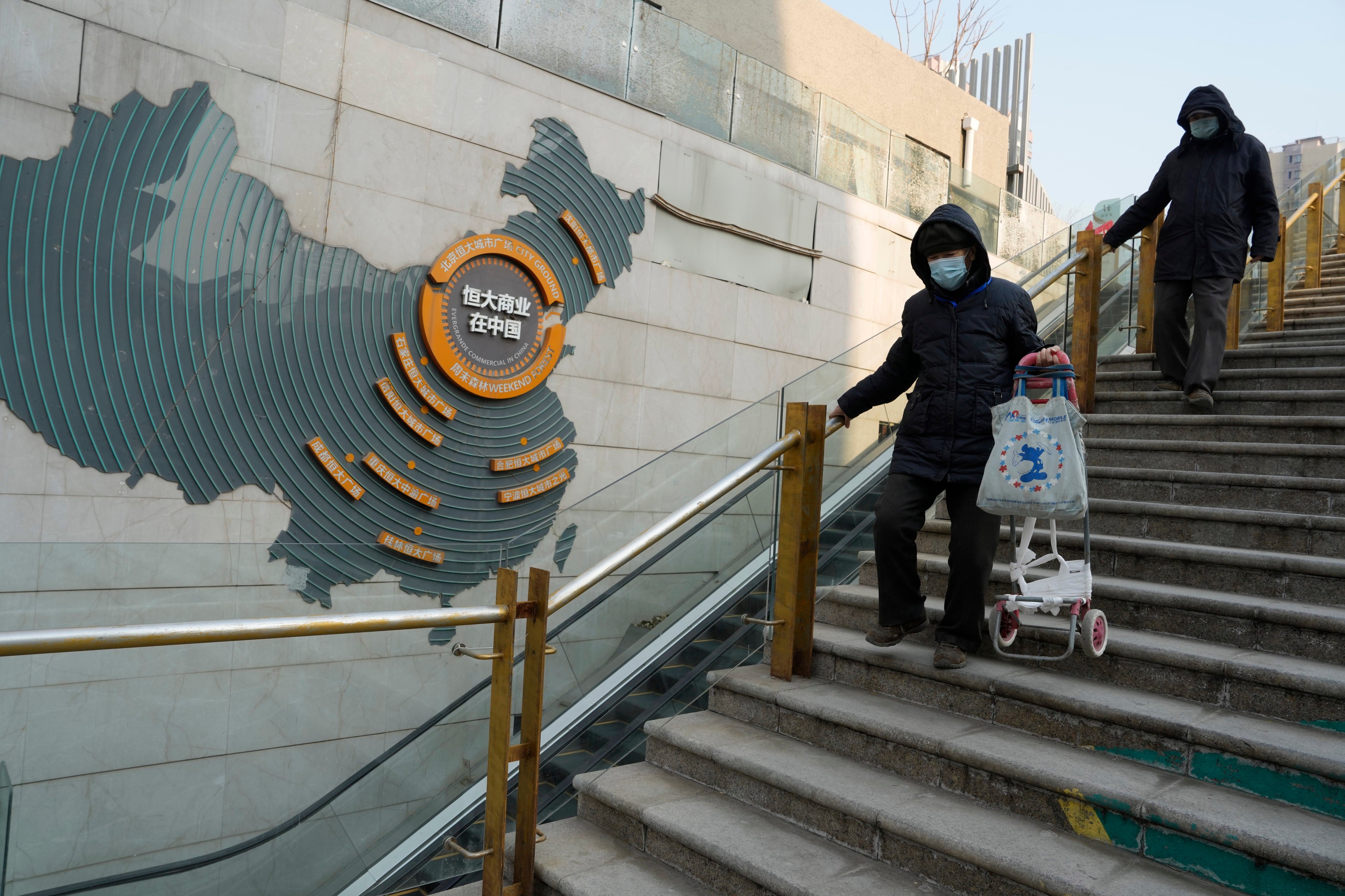 Residents walk through a partially shuttered Evergrande commercial complex in Beijing, on January 29. Photo: AP