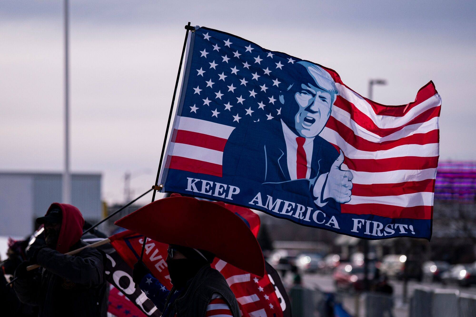 An attendee flies a flag supporting former US president Donald Trump ahead of a campaign event in Manchester, New Hampshire, on January 20. Trump’s pledge to expand his use of tariffs should he return to office has sparked concern among US businesses and allies. Photo: Bloomberg