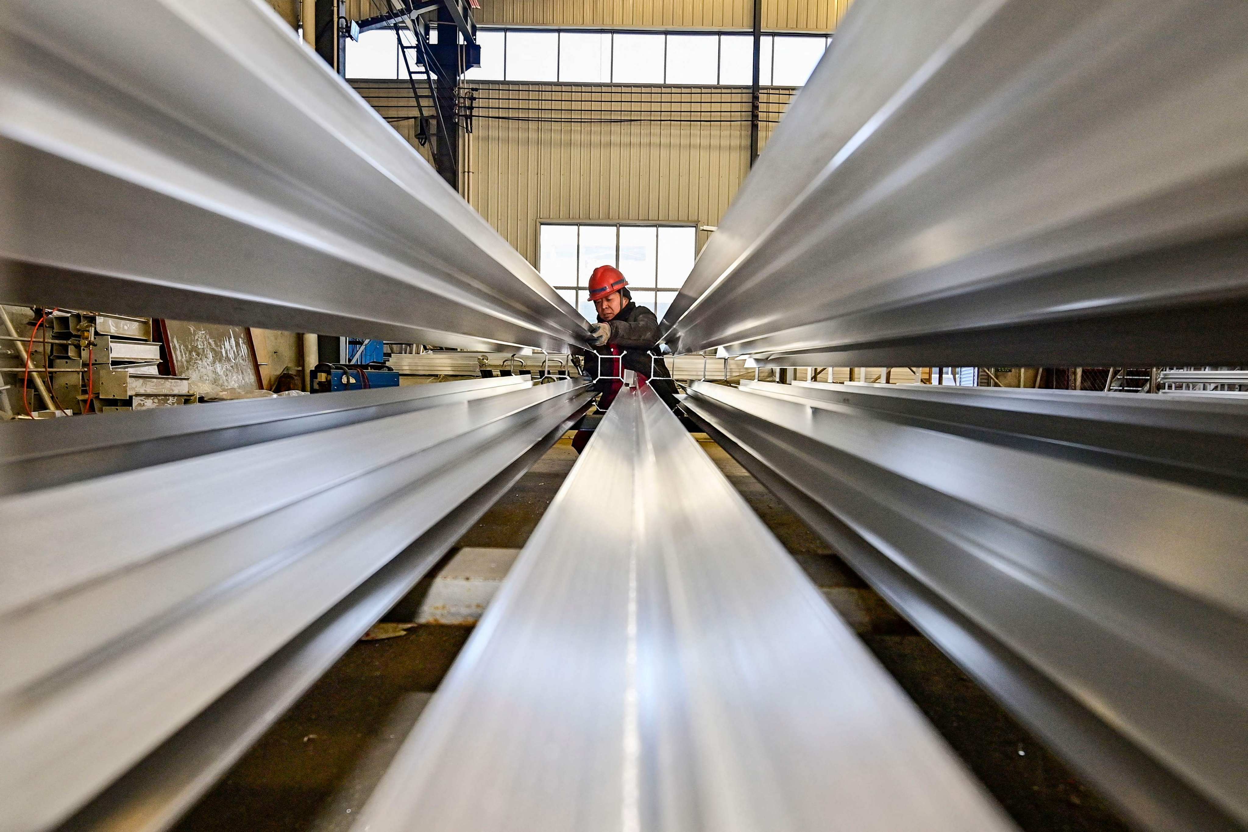An employee works on a steel pipe at a factory in Weifang, in China’s eastern Shandong provinc. The property sector and infrastructure are two of the largest segments fuelling China’s demand for products like steel, copper and aluminium. Photo: AFP