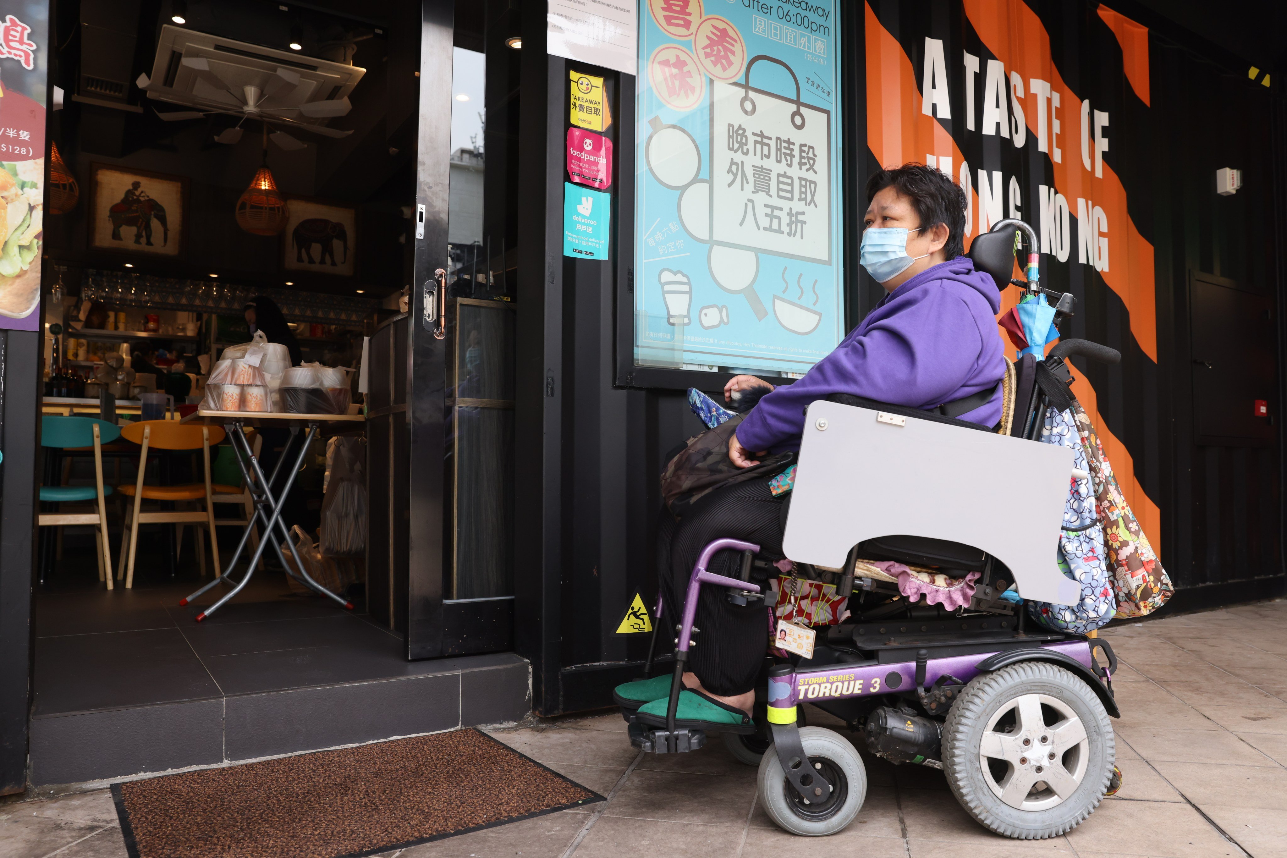 A wheelchair user finds herself obstructed by a step at the entrance of a restaurant in Cheung Sha Wan in December 2021. Universal design would make life easier not only for people in wheelchairs but parents with prams too. Photo: Nora Tam