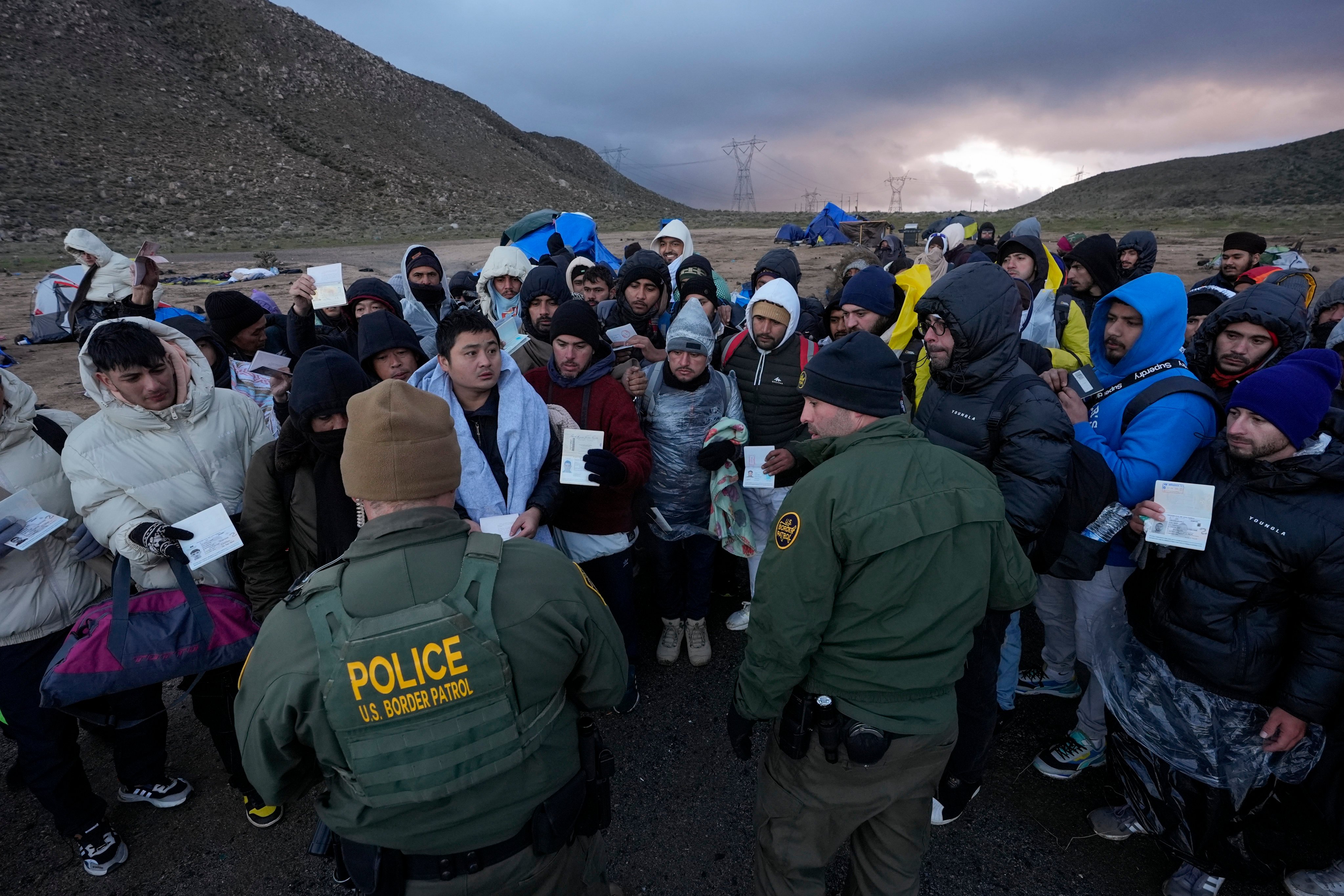Migrants after crossing the border between Mexico and the US, near Jacumba, California. Photo: AP