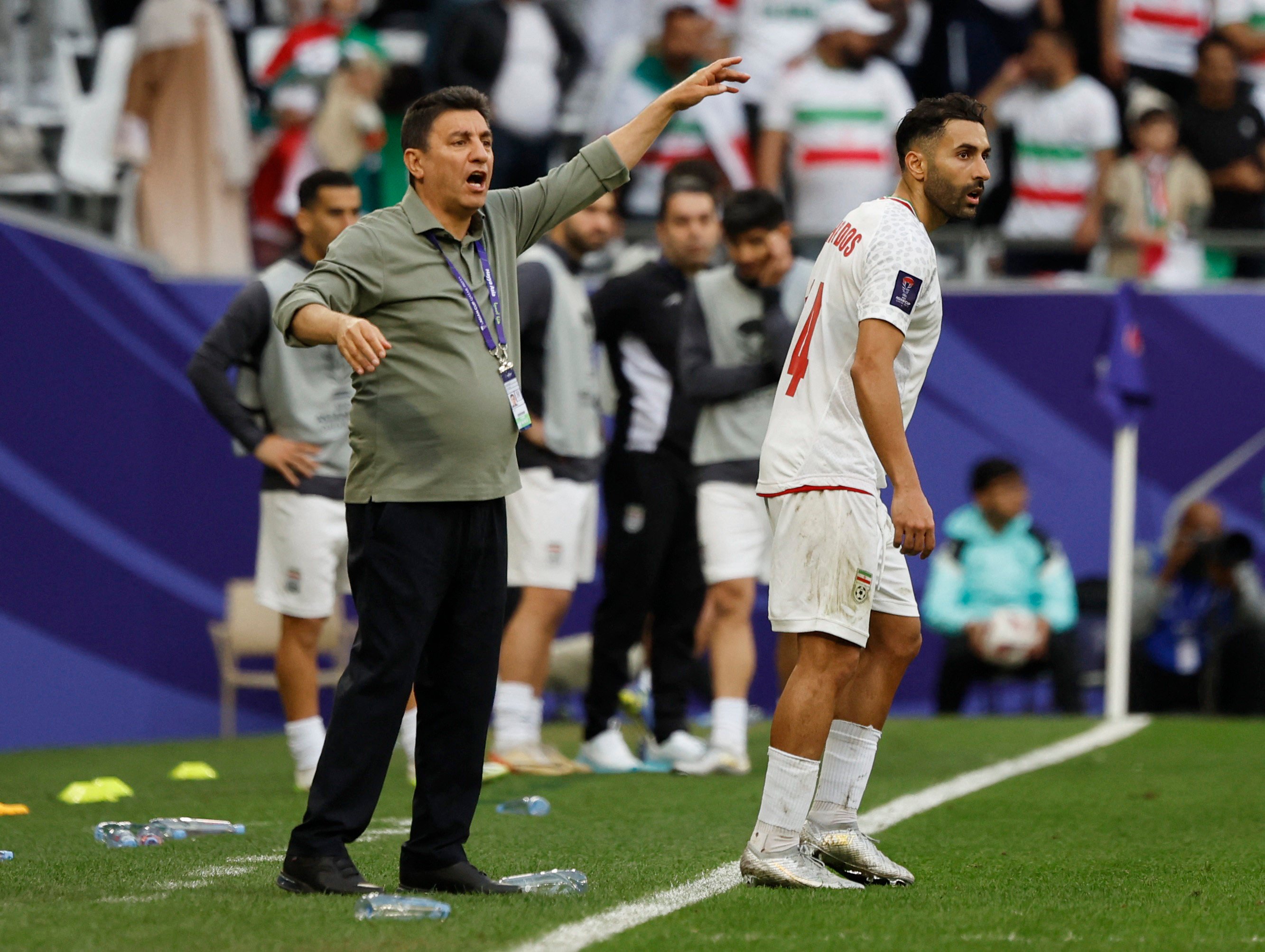 Iran coach Amir Ghalenoei shouts directions to his players during their quarter-final win over Japan. Photo: Reuters