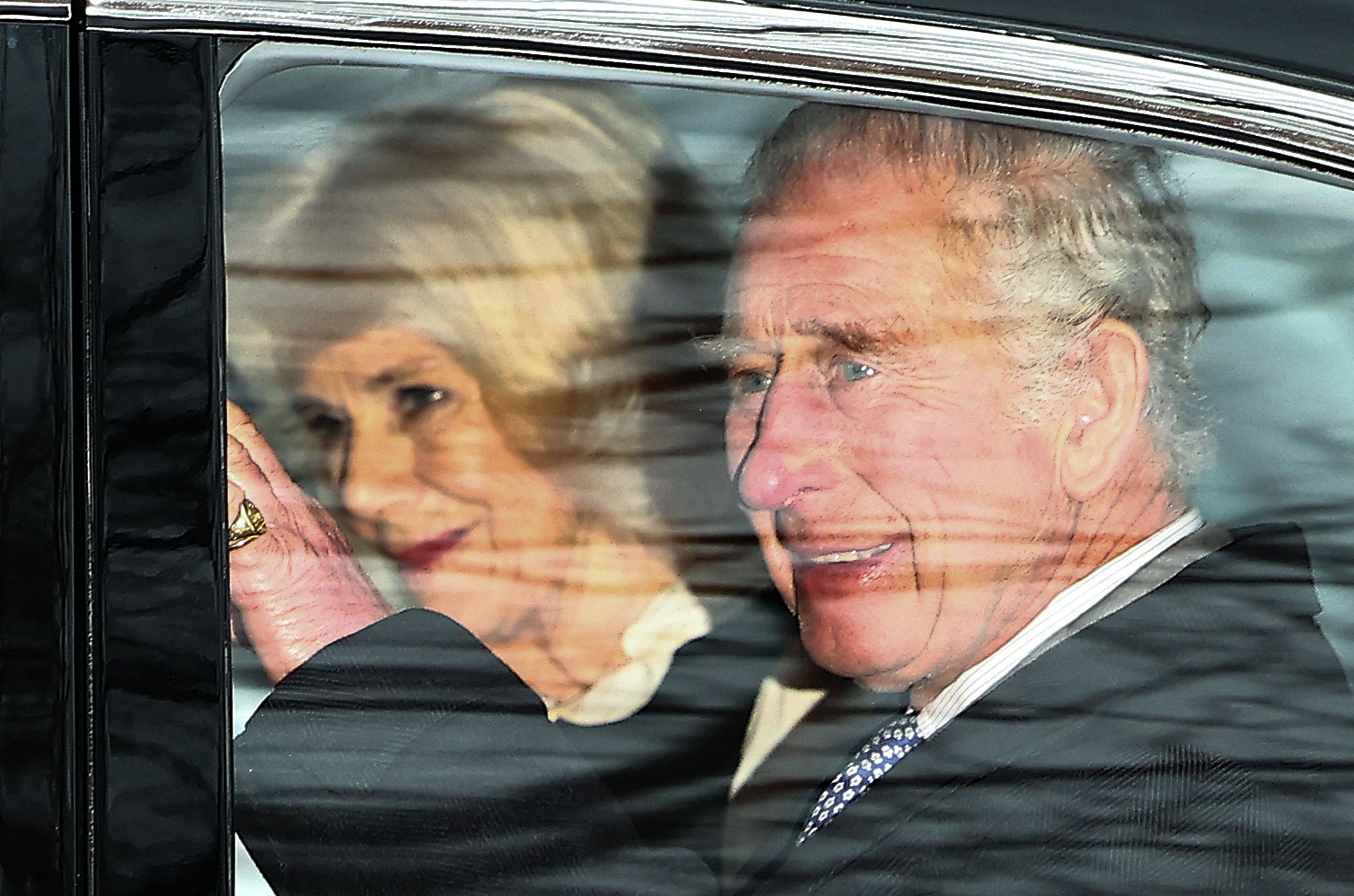 Britain’s King Charles and Queen Camilla wave as they leave by car from Clarence House in London on Tuesday. Photo: AFP