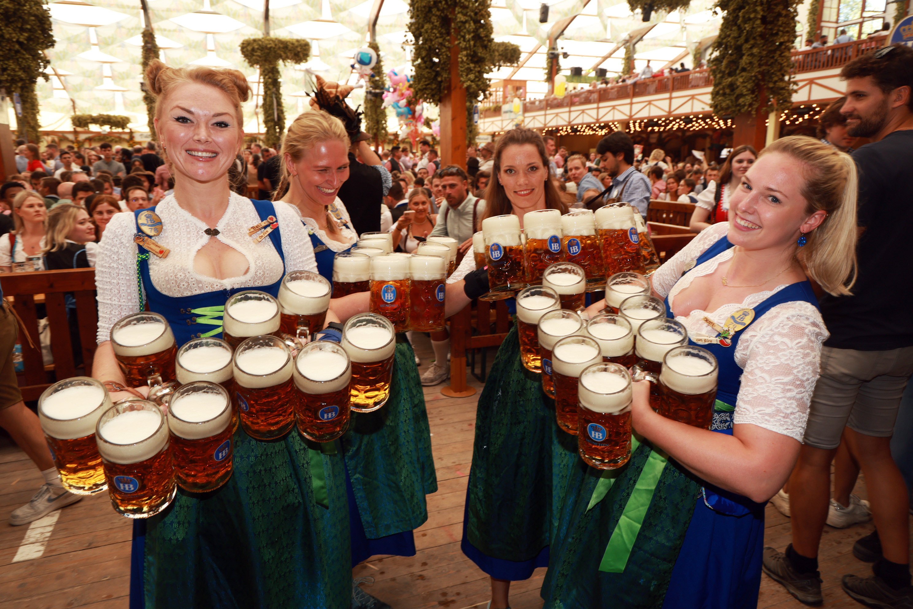 Waitresses of the Hofbraeu tent pose with 1 litre beer mugs on the opening day of the 2023 Munich Oktoberfest in Germany. Photo: Getty Images
