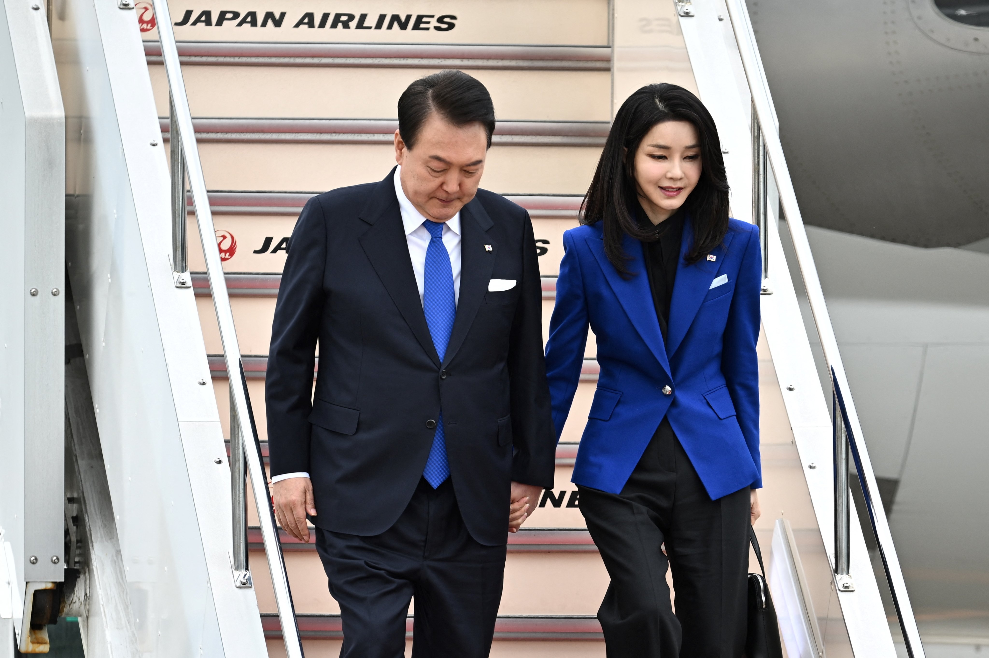 Yoon and his wife Kim Keon-hee arrive in Japan to attend a G7 Leaders’ Summit last year. Photo: AFP
