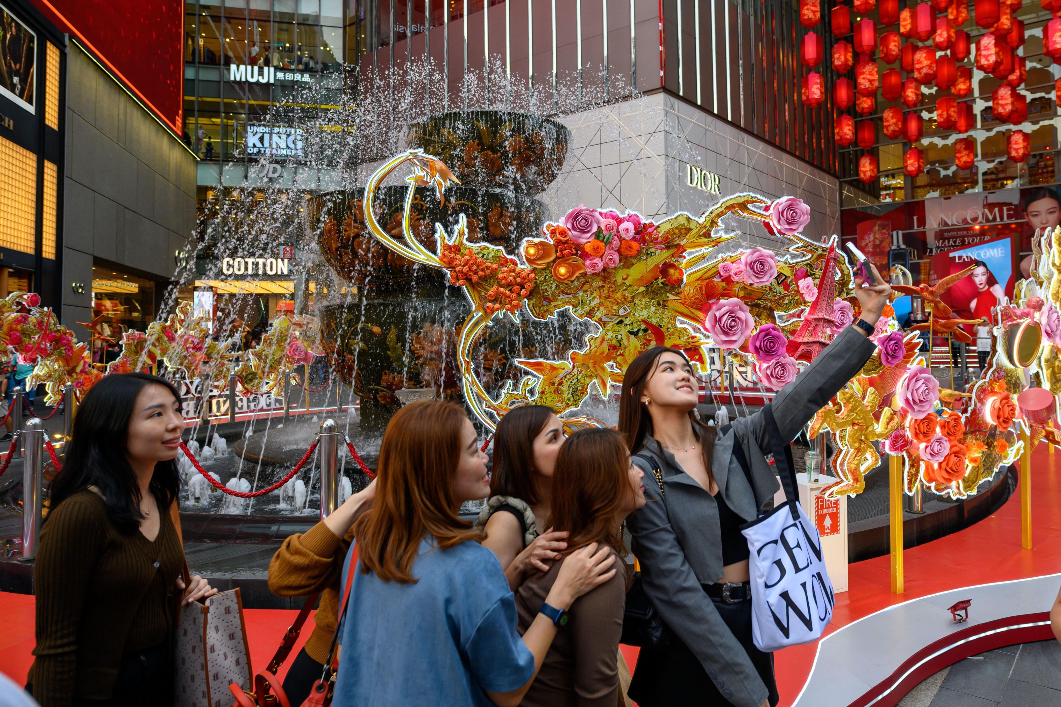 Shoppers pose for a selfie with a Lunar New Year-themed installation at a shopping centre in Malaysia last month. Photo: Xinhua
