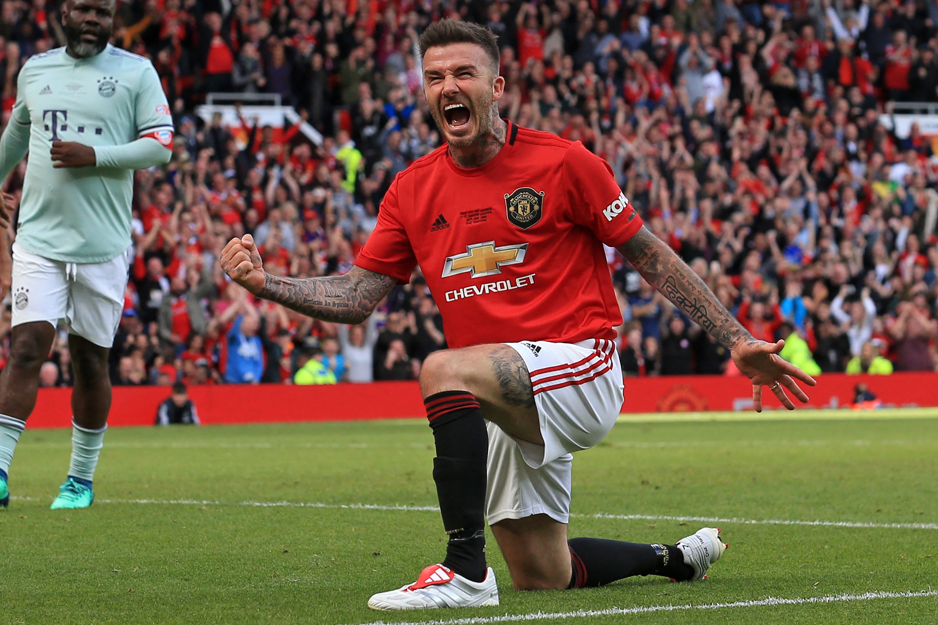 Manchester United ‘99 Legends player David Beckham celebrates after scoring their fifth goal during the Treble Reunion 20th anniversary football match between Manchester United ‘99 Legends and FC Bayern Legends at Old Trafford in Manchester, north-west England on May 26, 2019. Photo: AFP