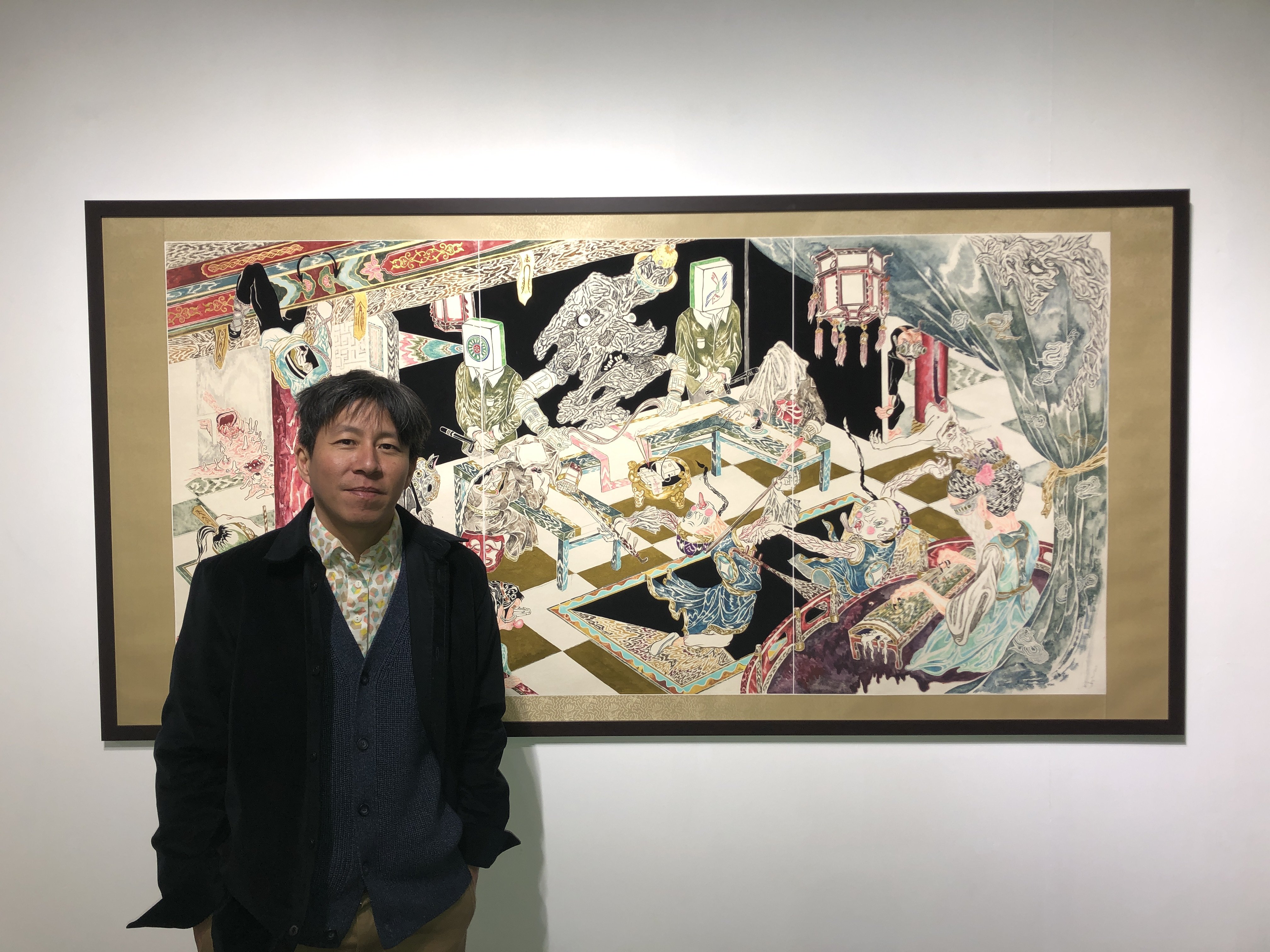 Hong Kong-born, Canada-based artist Howie Tsui stands in front of “The Banquet” (2023), part of his solo exhibition at Hanart TZ Gallery in Kwai Chung, Hong Kong. Tsui says his practice is inspired by the likes of Jin Yong’s wuxia martial arts novels. Photo: Enid Tsui