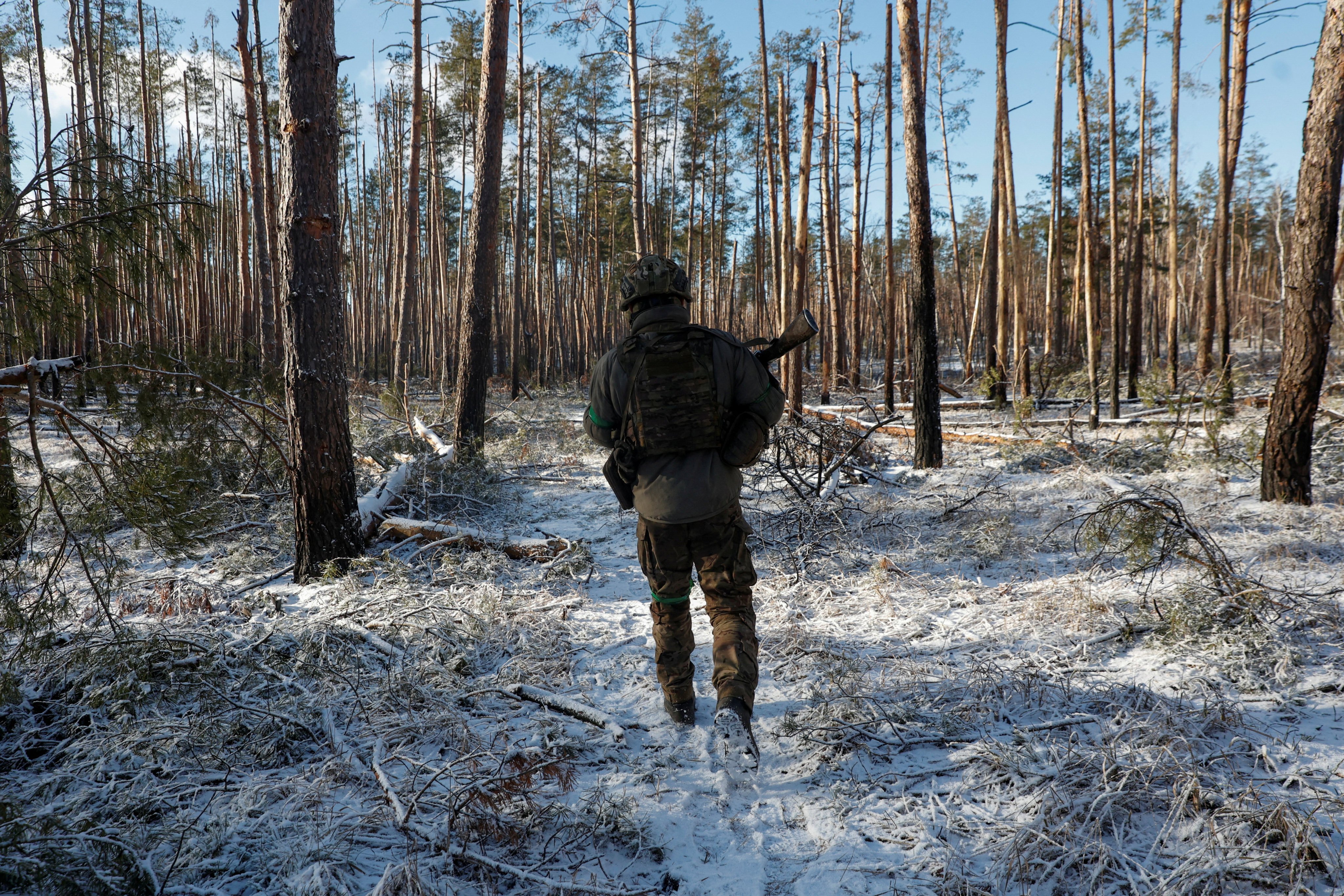 A Ukrainian serviceman walks among damaged trees on the front line near the town of Kreminna, in eastern Ukraine, on February 6. The West explains the Ukraine war in terms of standing on principle – the enemy struck the first blow and is therefore the bully – ignoring history and context. Photo: Reuters 