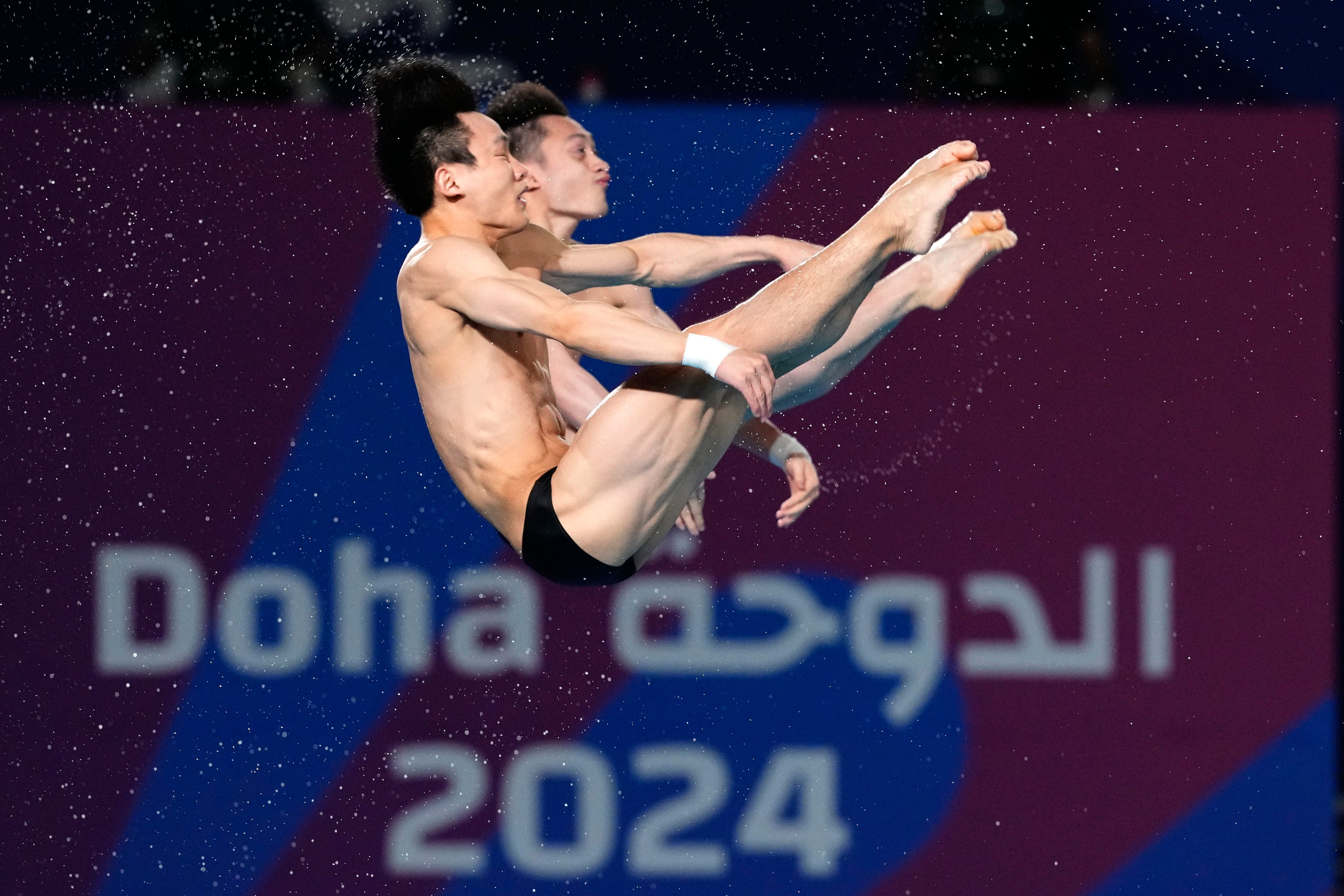 Lian Junjie and Yang Hao  compete during the men’s synchronized 10m platform diving final at the World Aquatics Championships in Doha, Qatar. Photo: AP
