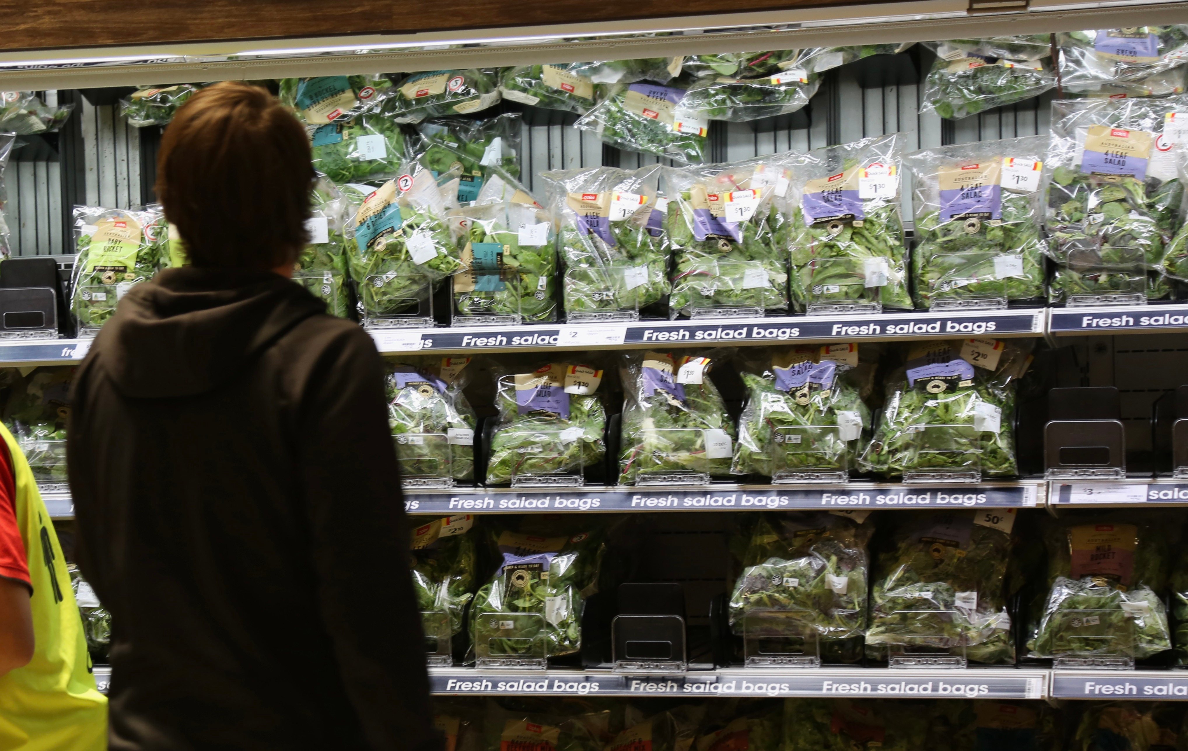 A customer looks at baby spinach at a supermarket in Sydney. With the price of other goods including energy also soaring, a cost of living crisis is dominating national discourse in Australia. Photo: Xinhua