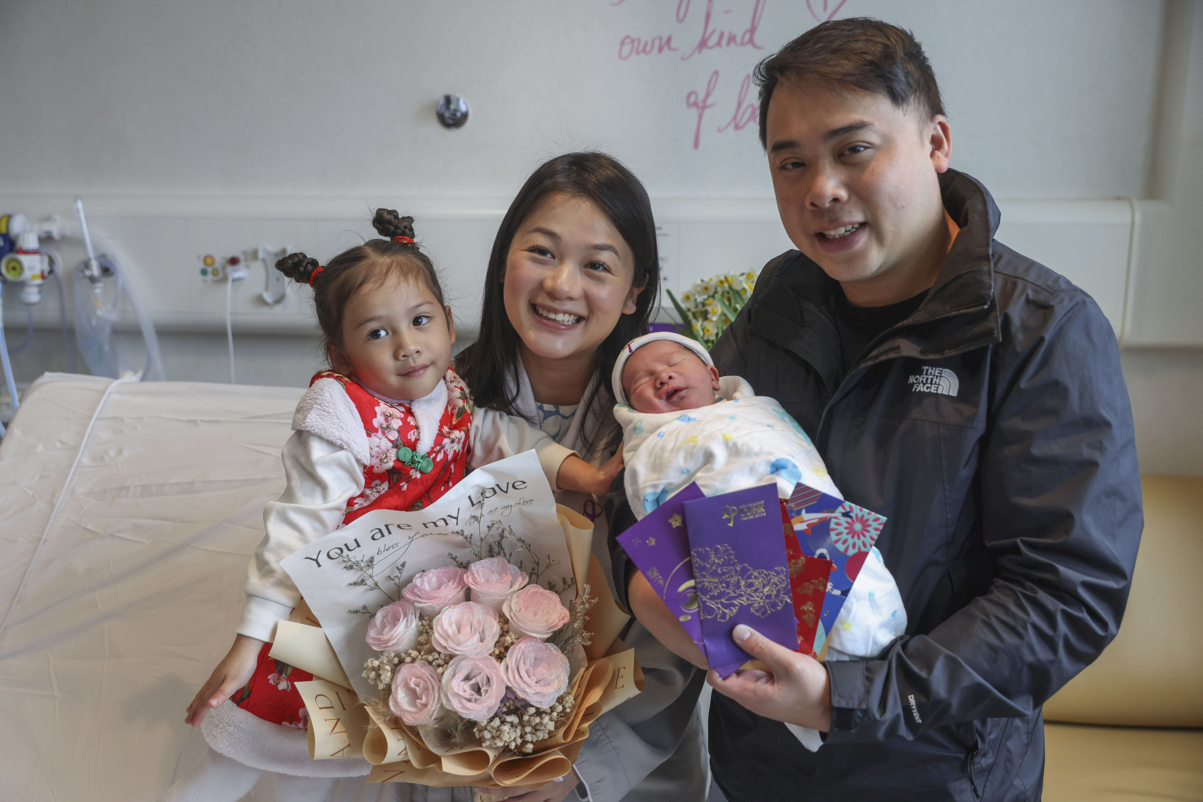 Miles, a “dragon baby”, with his parents Kelvin and Judy Chan, and big sister Leah at the CUHK Medical Centre in Sha Tin. Photo: Yik Yeung-man
