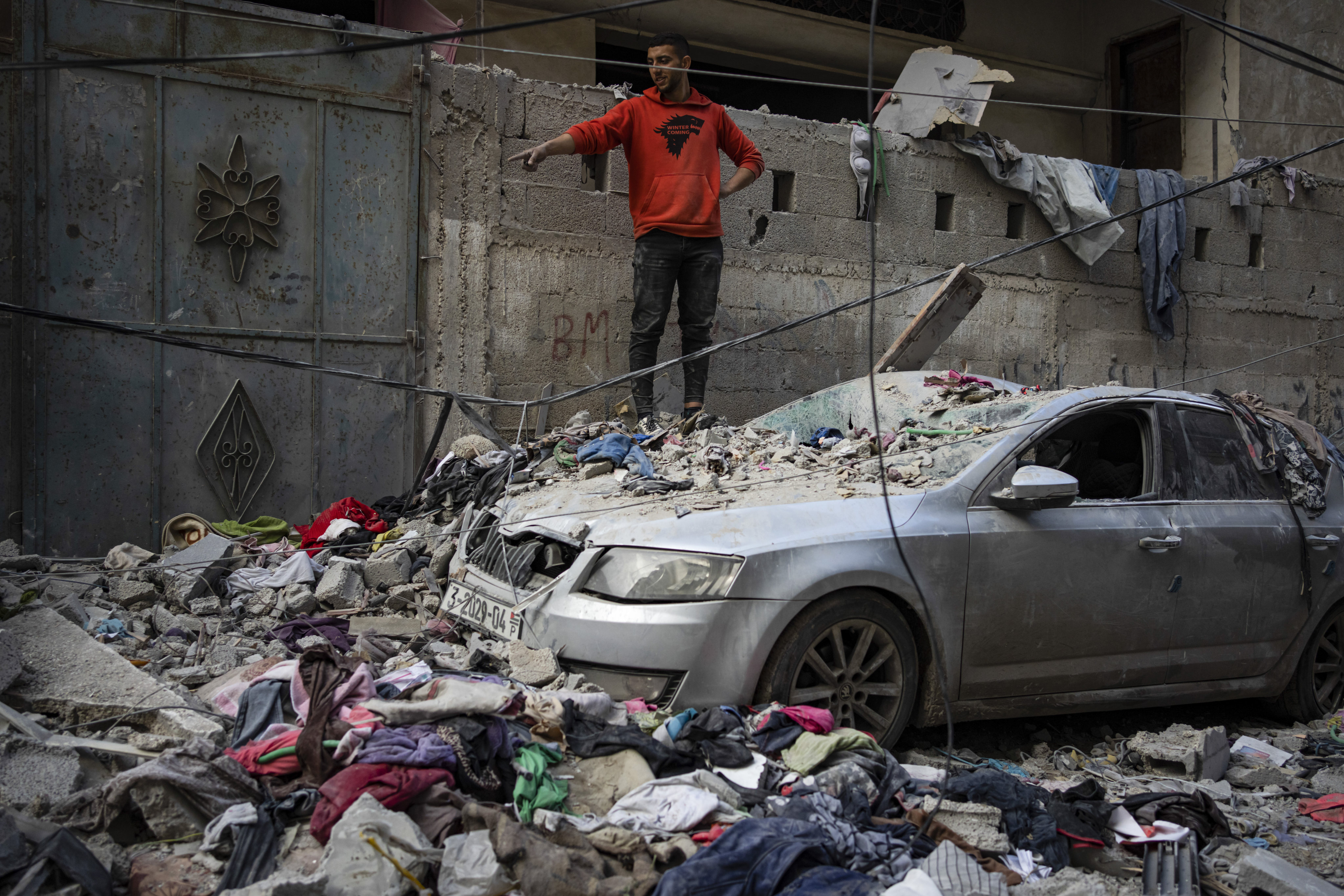 Palestinians look at the destruction after an Israeli strike in Rafah on Friday. Photo: AP