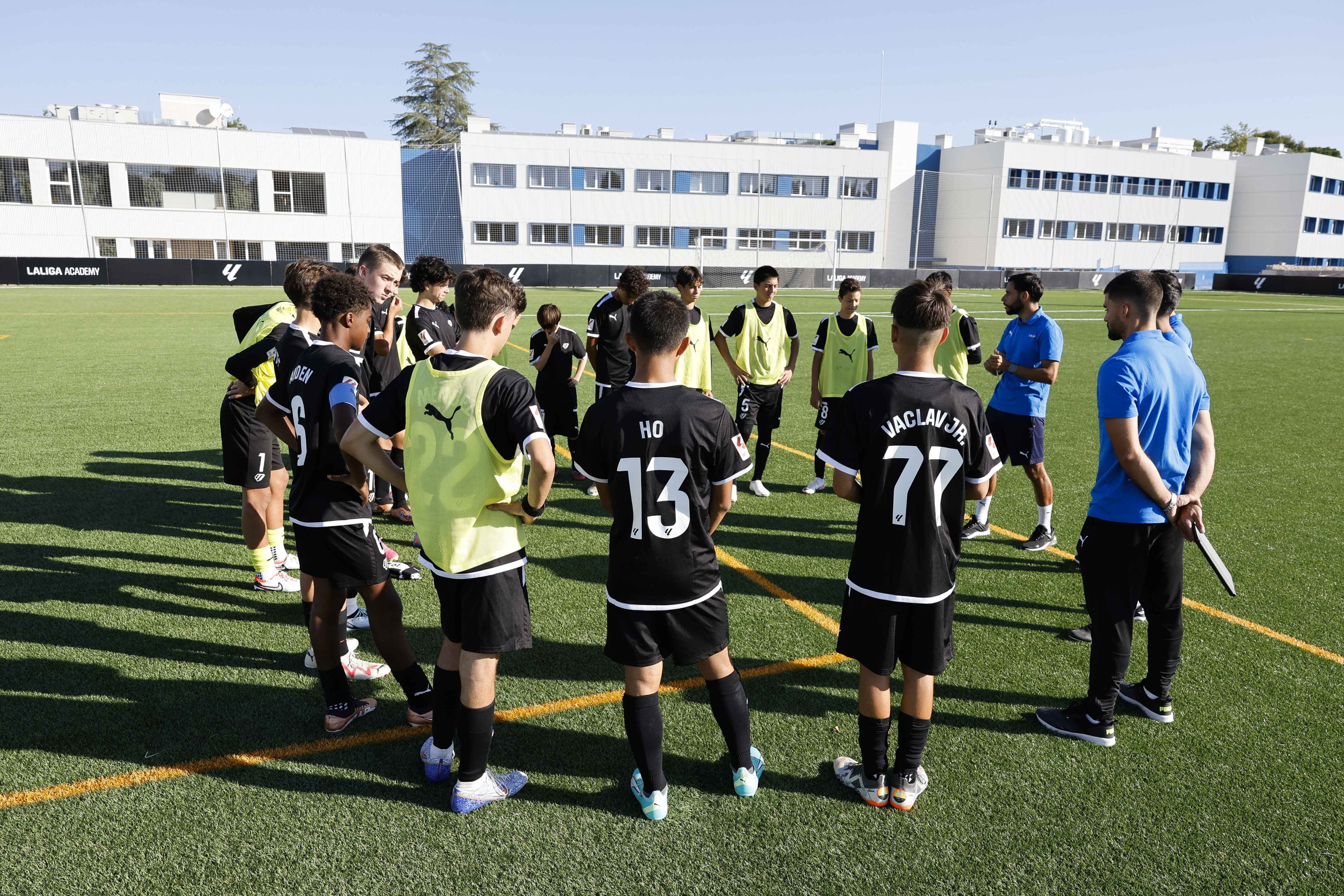 Players listen to their coach during a training session at La Liga Academy in Madrid. Photo: La Liga Academy