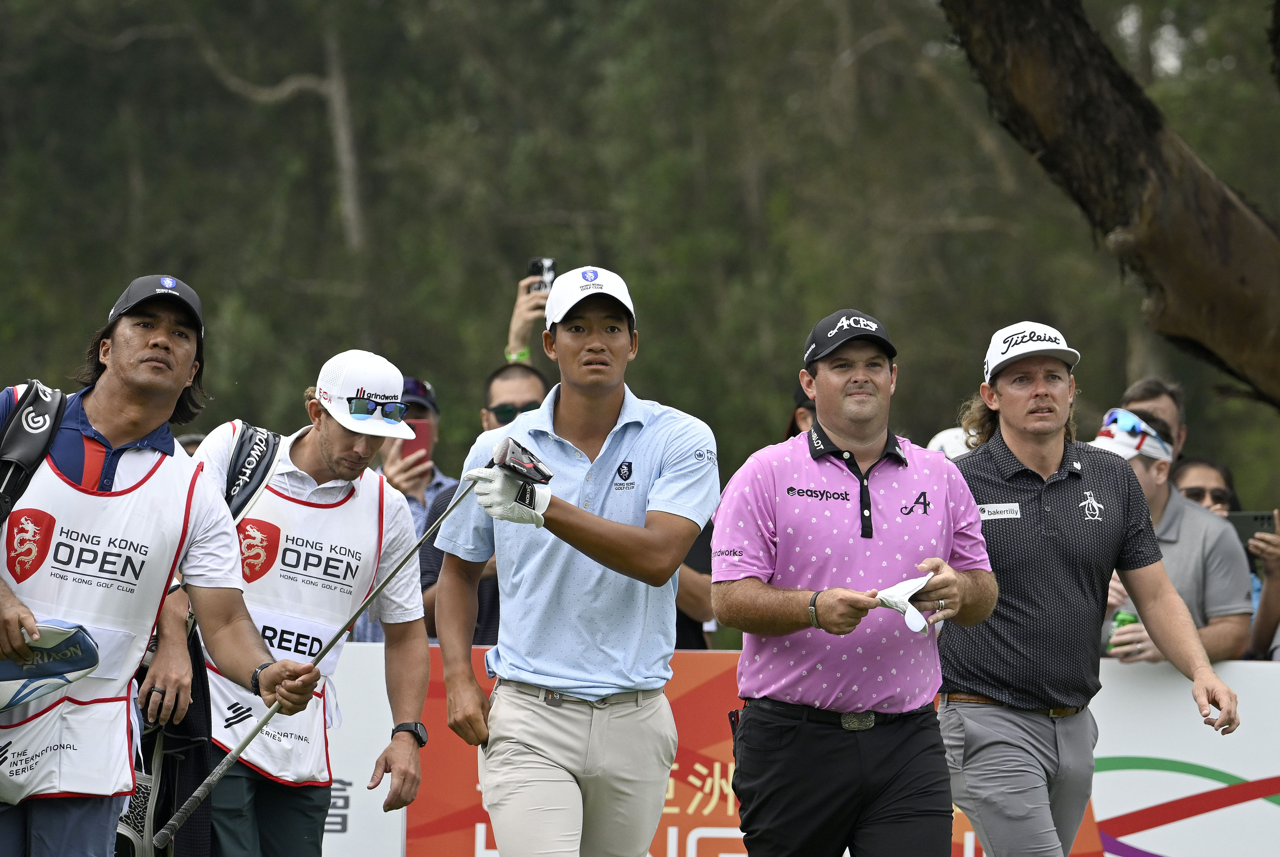 Taichi Kho (centre), Patrick Reed and Cameron Smith  walk off the 18th tee together during the first round of the 2023 Hong Kong Open. Photo: Asian Tour.