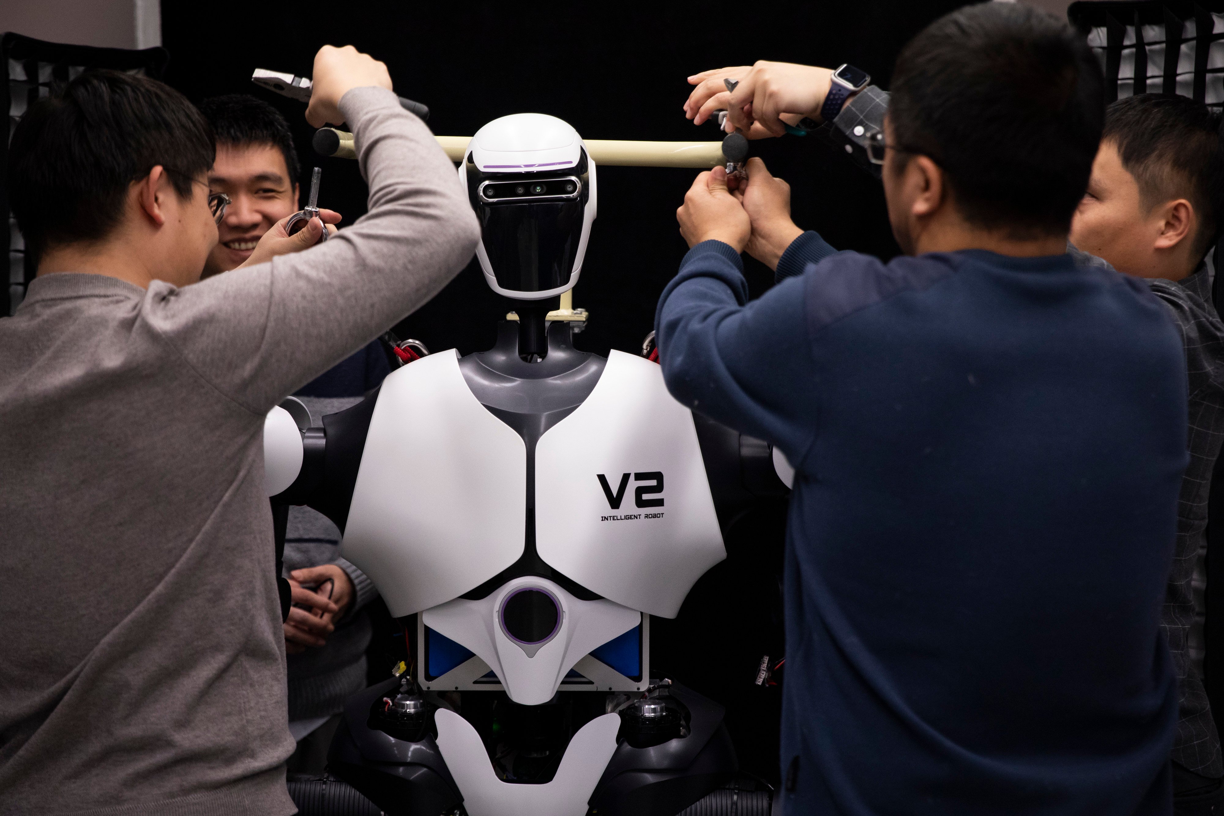 Researchers adjust a humanoid robot at an AI laboratory in Beijing on January 31. Photo: Xinhua
