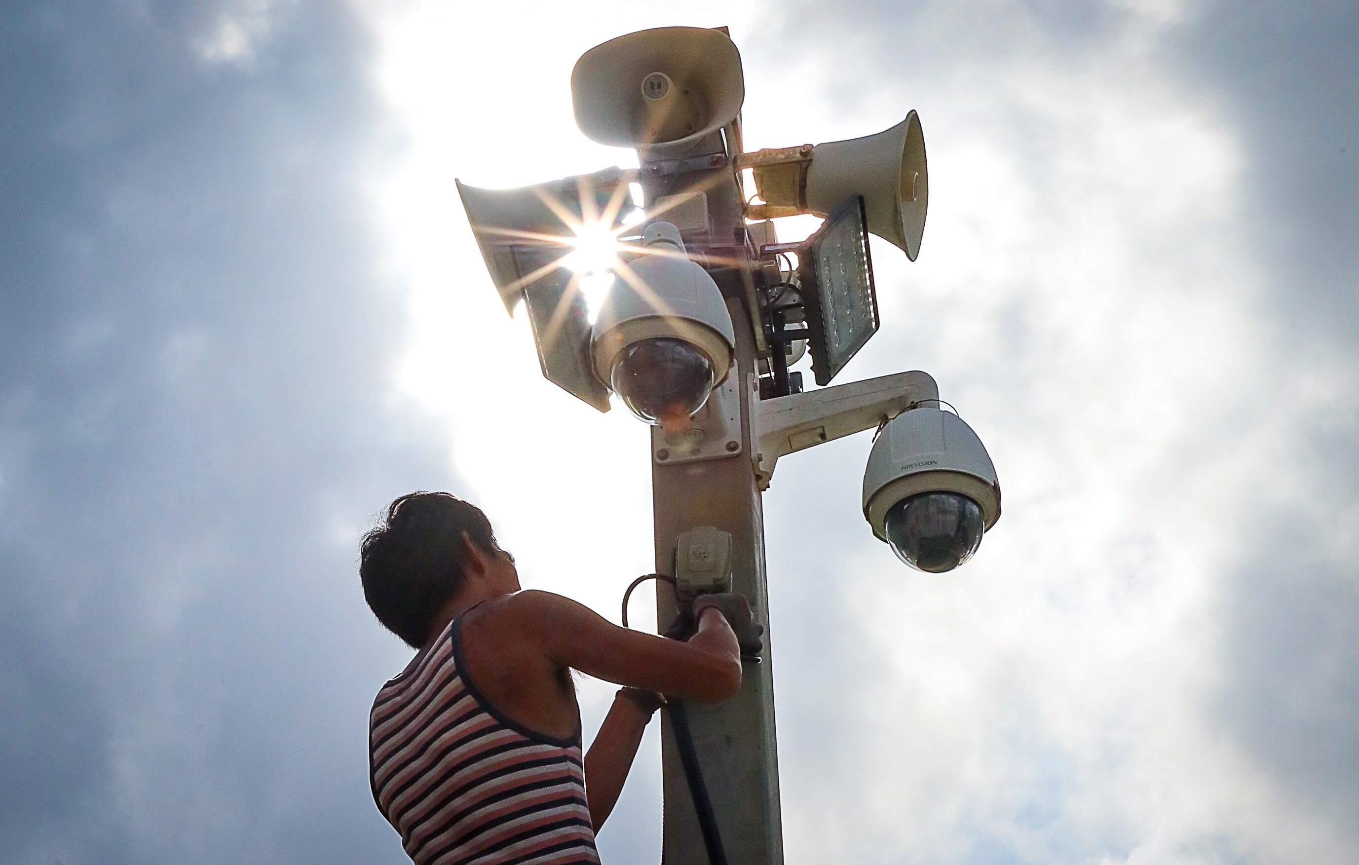 A worker installs a CCTV camera in Tamar. The city plans to install 2,000 cameras by the end of 2024. Photo: Felix Wong