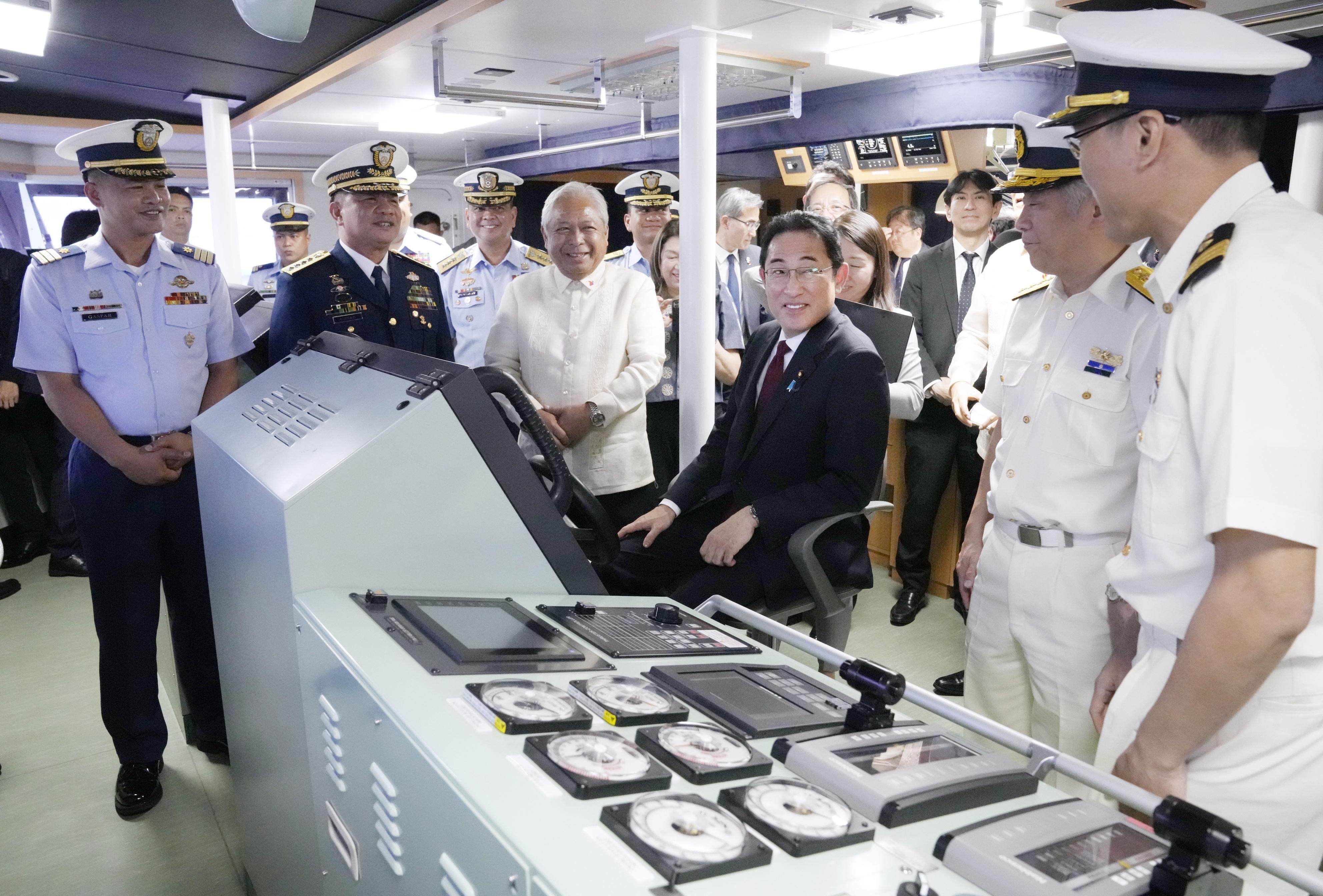 Japanese Prime Minister Fumio Kishida (seated) visits a Philippine Coast Guard vessel in Manila on November 4, 2023, during a three-day official visit to Southeast Asia. Photo: Kyodo