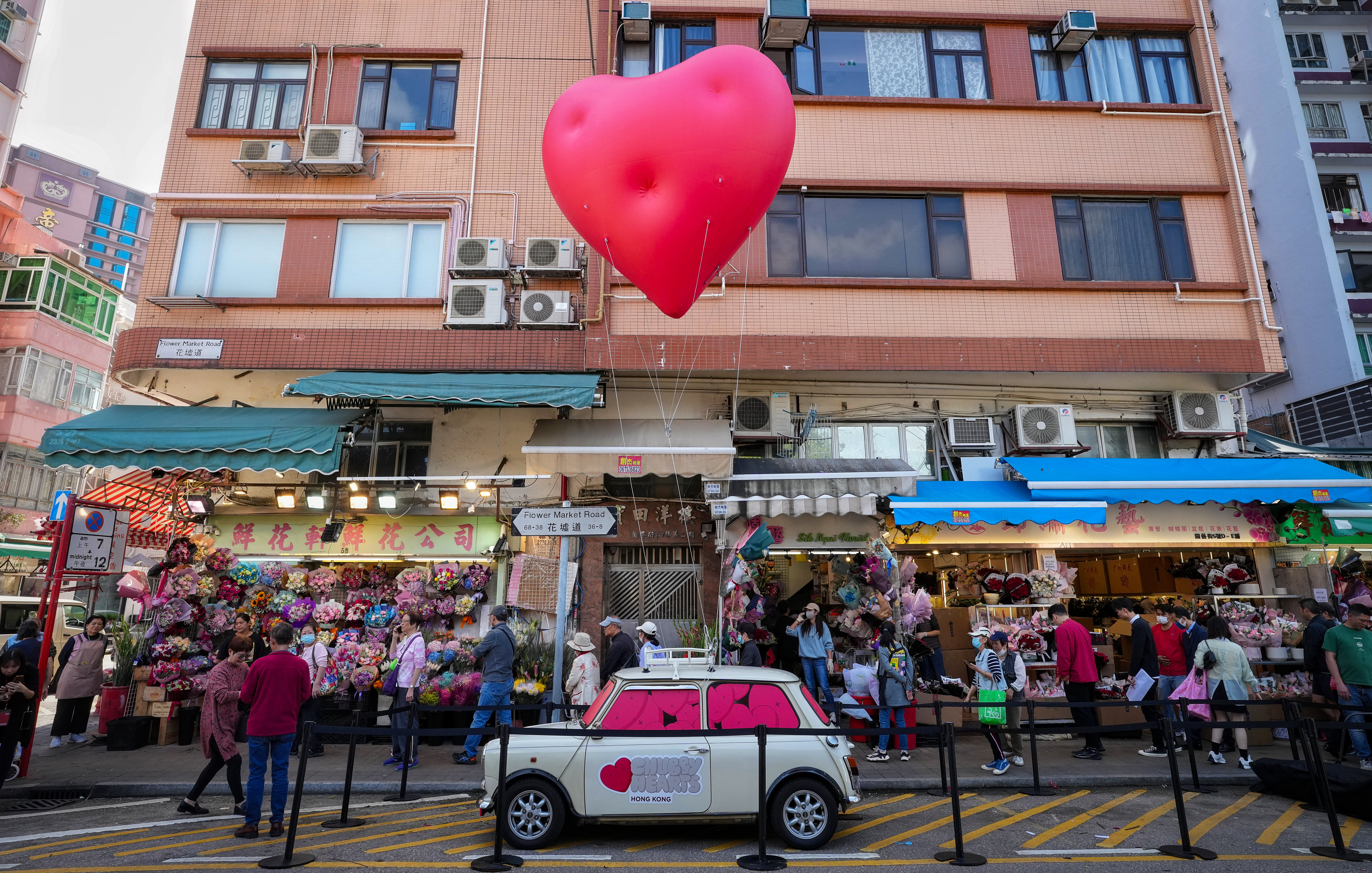 A pop-up Chubby Heart floats in the air at the flower market of Mong Kok. Photo: Elson Li