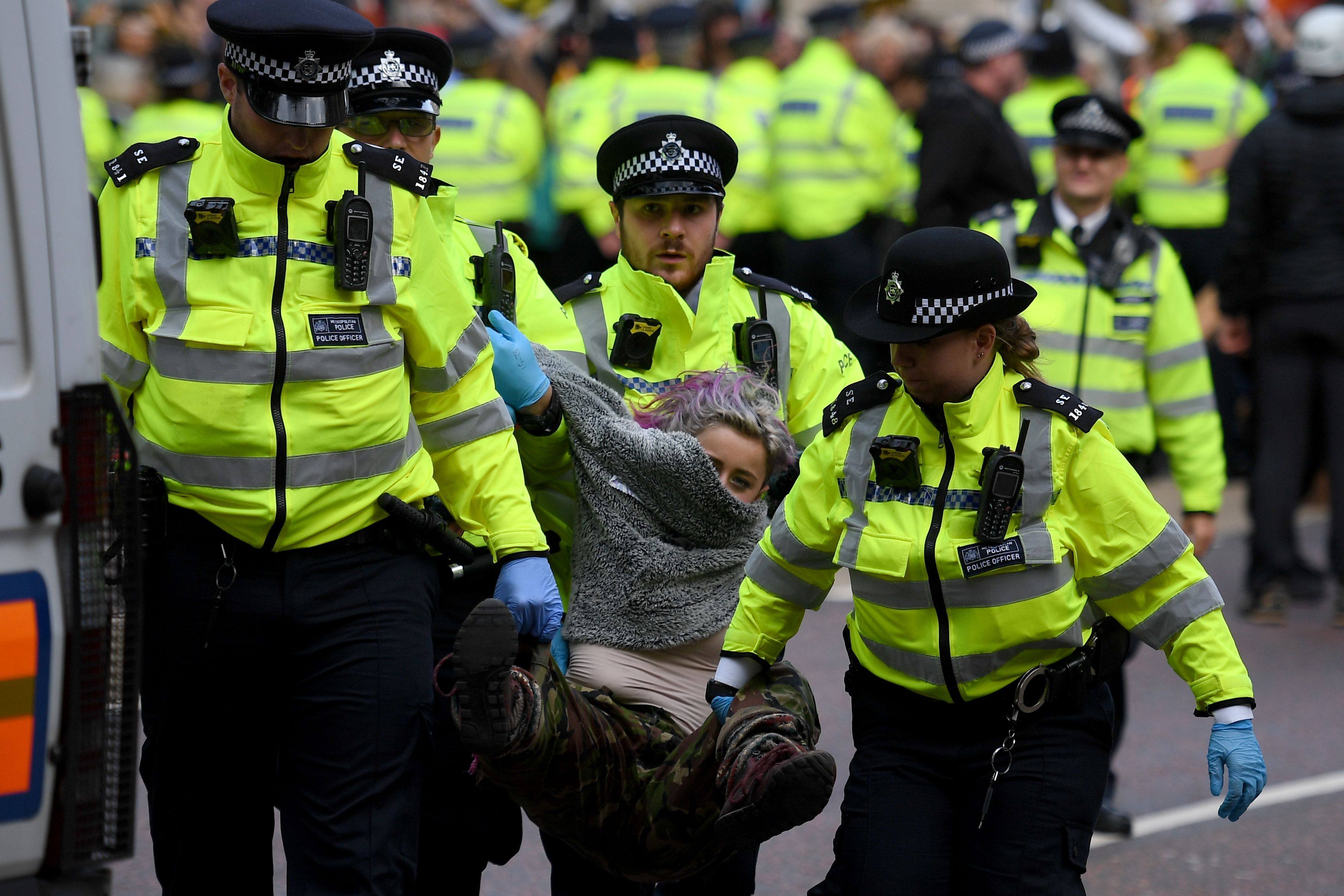 Police arrest a climate activist during the third day of climate change demonstrations by the Extinction Rebellion group, in Westminster, central London, on October 9, 2019. Photo: AFP