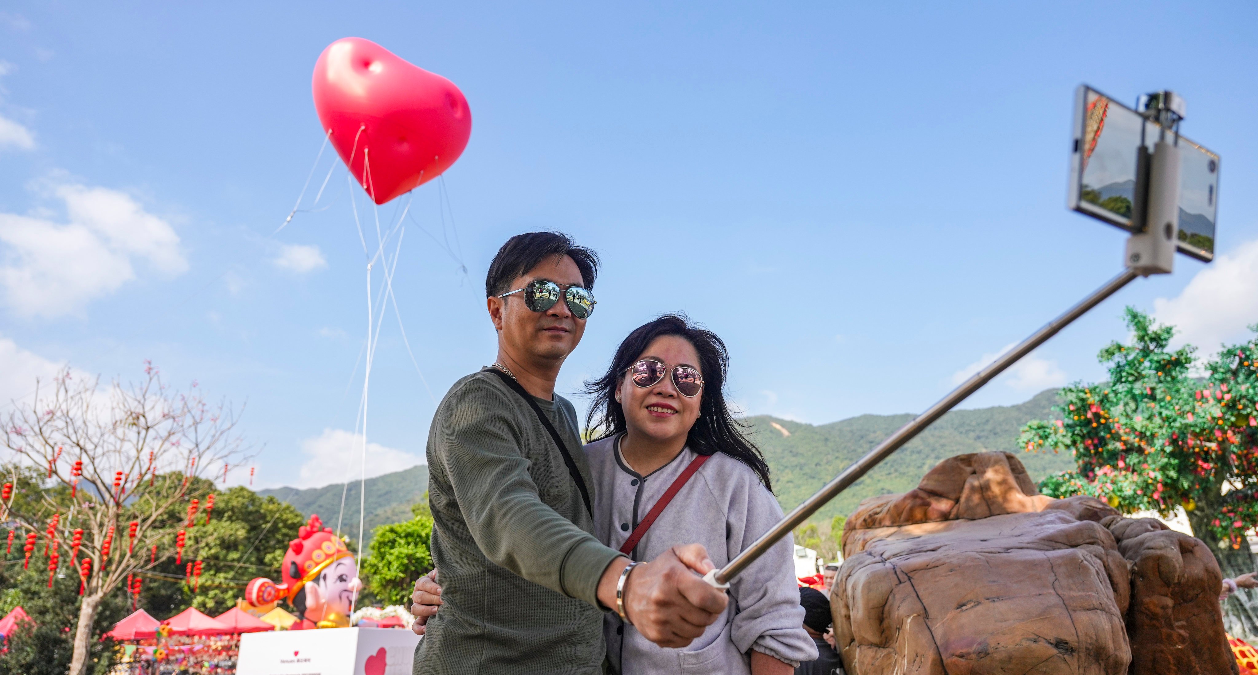 A couple takes selfies in front of a “Chubby Hearts” art installation by fashion designer Anya Hindmarch in Lam Tsuen, Tai Po, on Valentine’s day. Photo: Eugene Lee