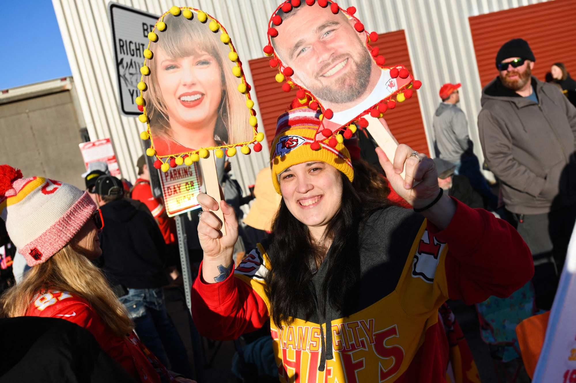 A fan holds up pictures of singer Taylor Swift and Travis Kelce of the Kansas City Chiefs during the Super Bowl victory parade in Kansas City, Missouri, on Wednesday. Photo: AFP