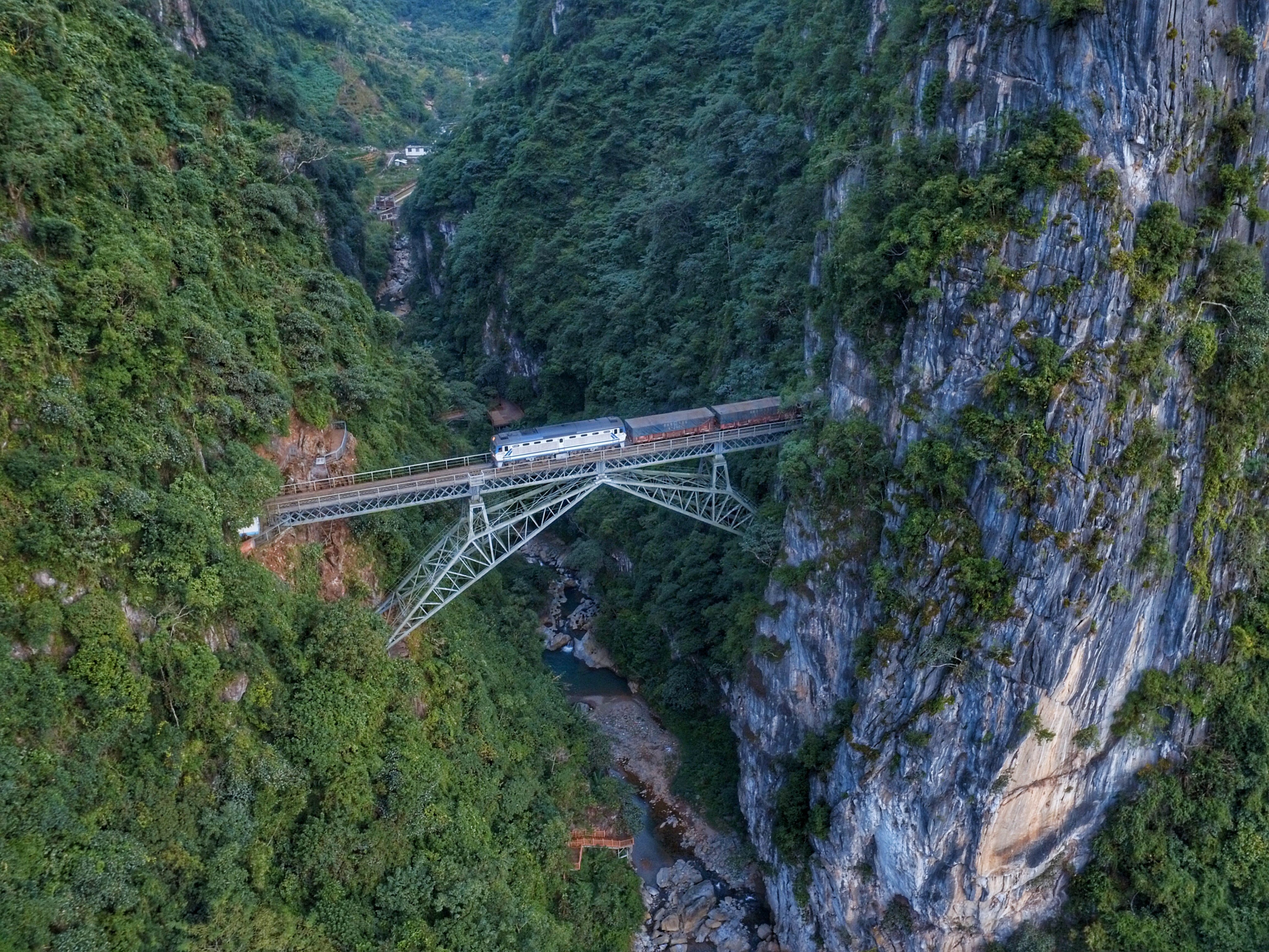 A freight train passes over a gabled bridge in Honghe prefecture, Yunnan province, southwest China, known as the Renzi Bridge and designed by French engineer Paul Bourdon, in July 2017. Photo: Wang Lu