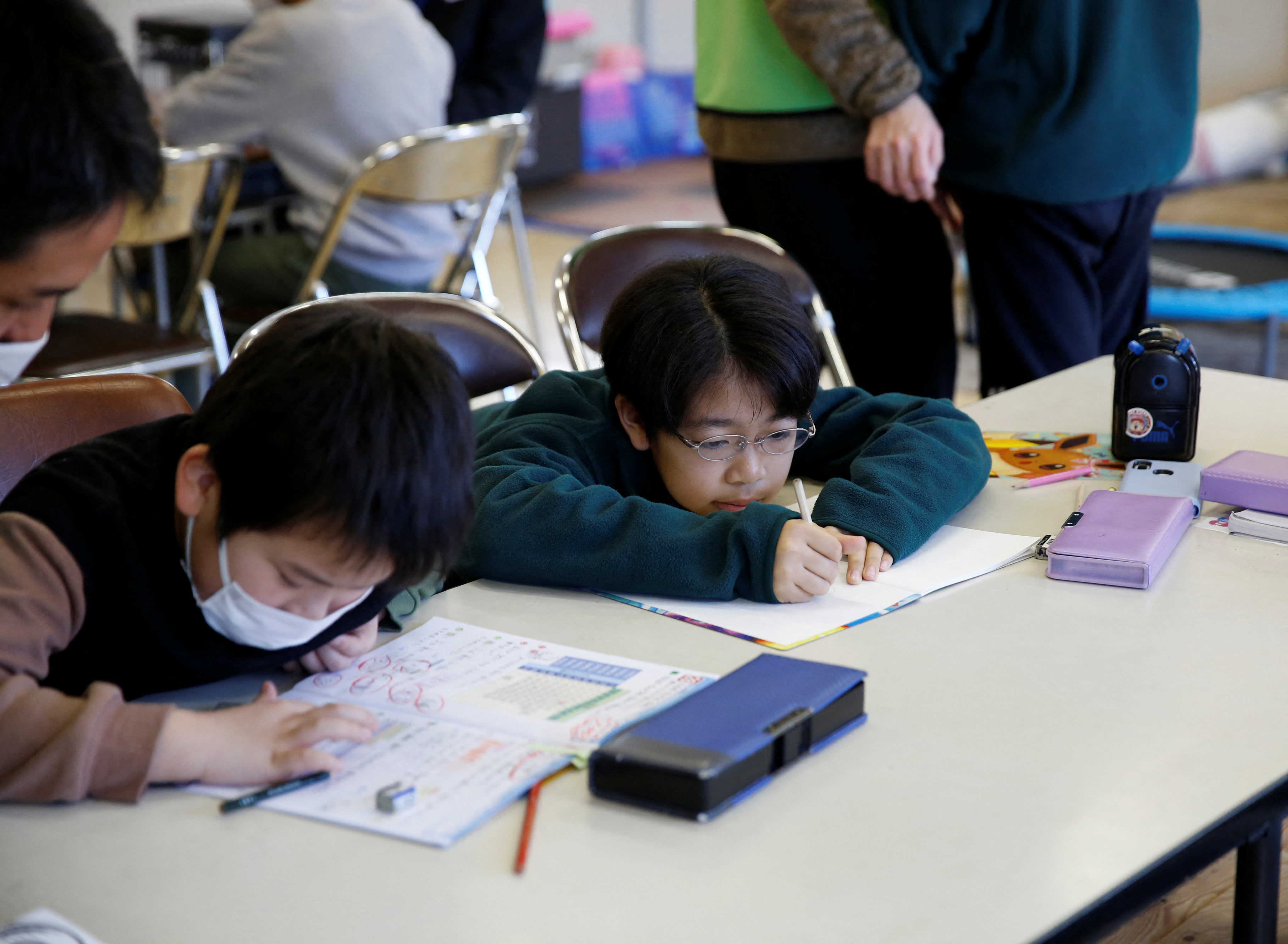 Children do their homework at a children’s play space open for survivors of the earthquake in Suzu. The government plans to boost annual spending on child care and bring it to 16 per cent of gross domestic product from 11 per cent. Photo: Reuters