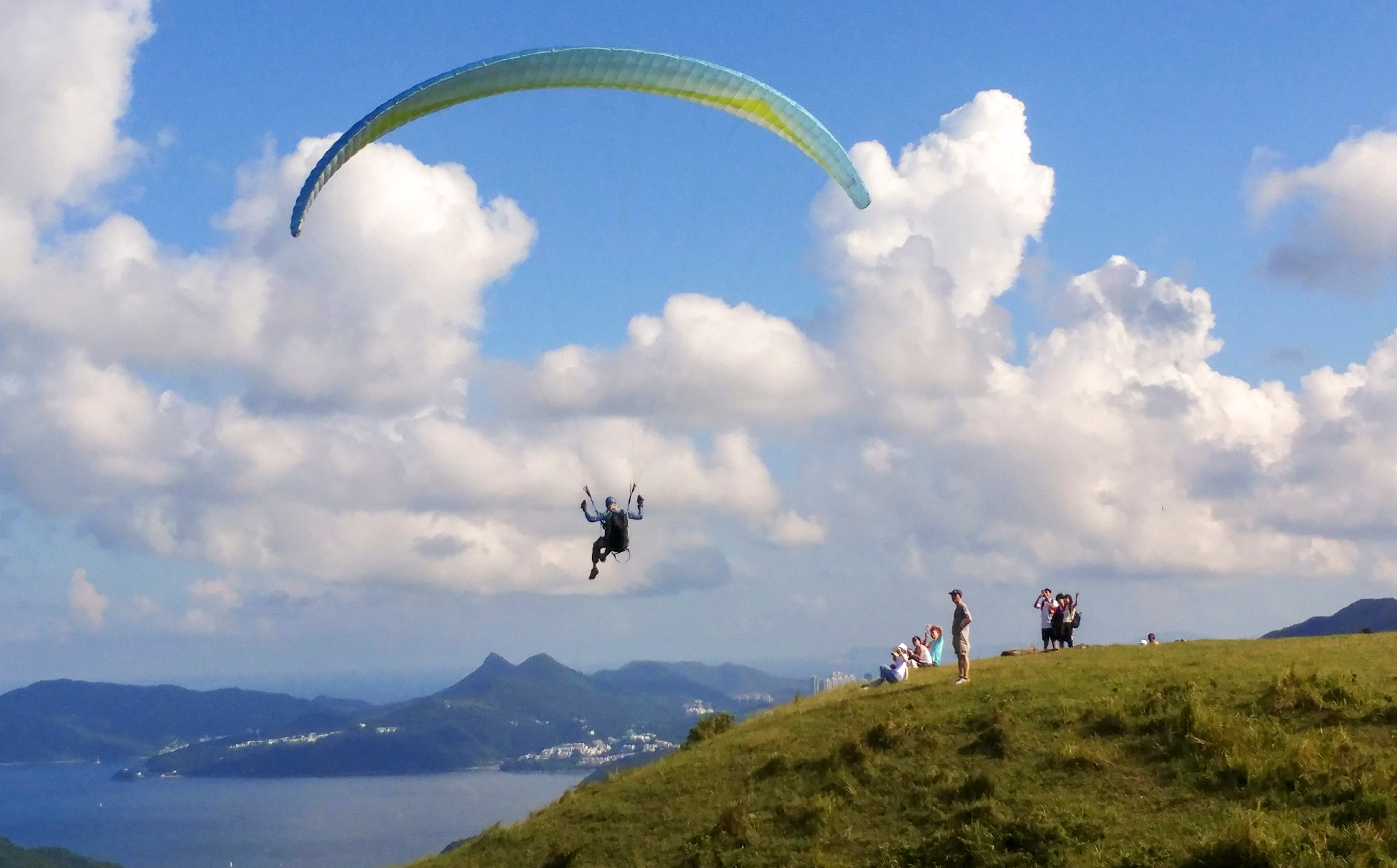 A paraglider in Sai Kung takes to the skies. Police said a 67-year-old man made an emergency landing while paragliding on Friday. Photo: Felix Wong